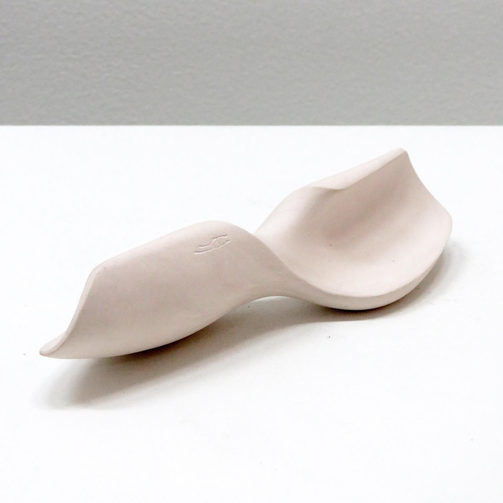 stunning palm stone titled 'propeller', handcrafted by Los Angeles based ceramicist Jed Farlow. A one-of-a-kind unglazed porcelain sculpture, part of an ongoing 'Bone' series. Each of these unique pieces is meticulously crafted and meant to be hand