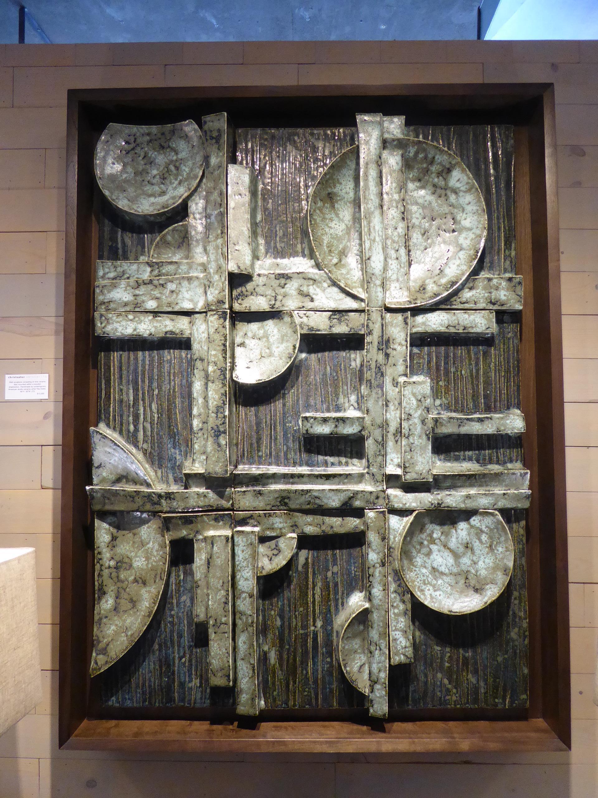 This nine-part custom framed ceramic panel is titled 
