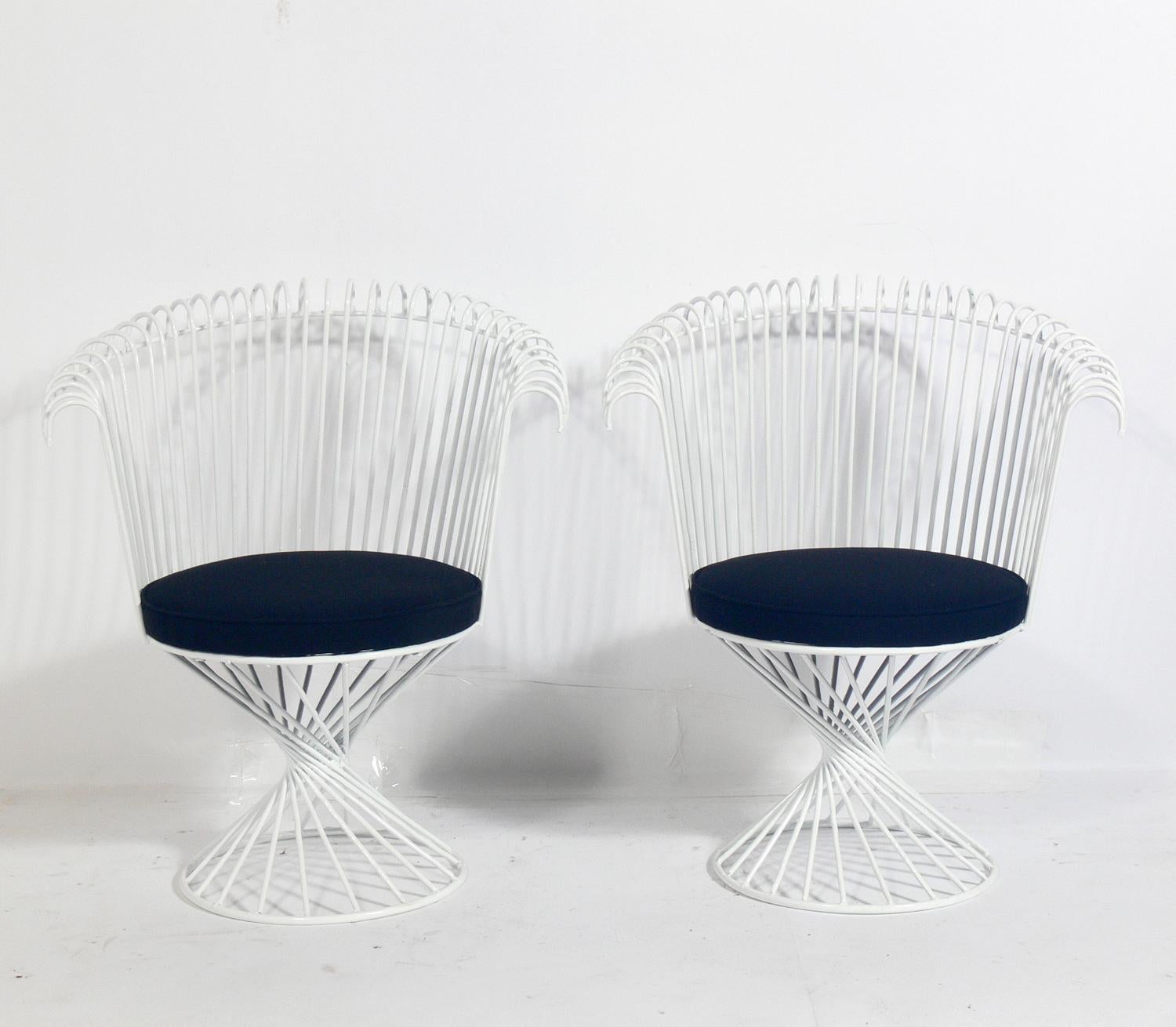 Sculptural patio chairs in the manner of Mathieu Matégot, France, circa 1960s. They have been recently powder-coated and reupholstered in an exterior grade fabric.