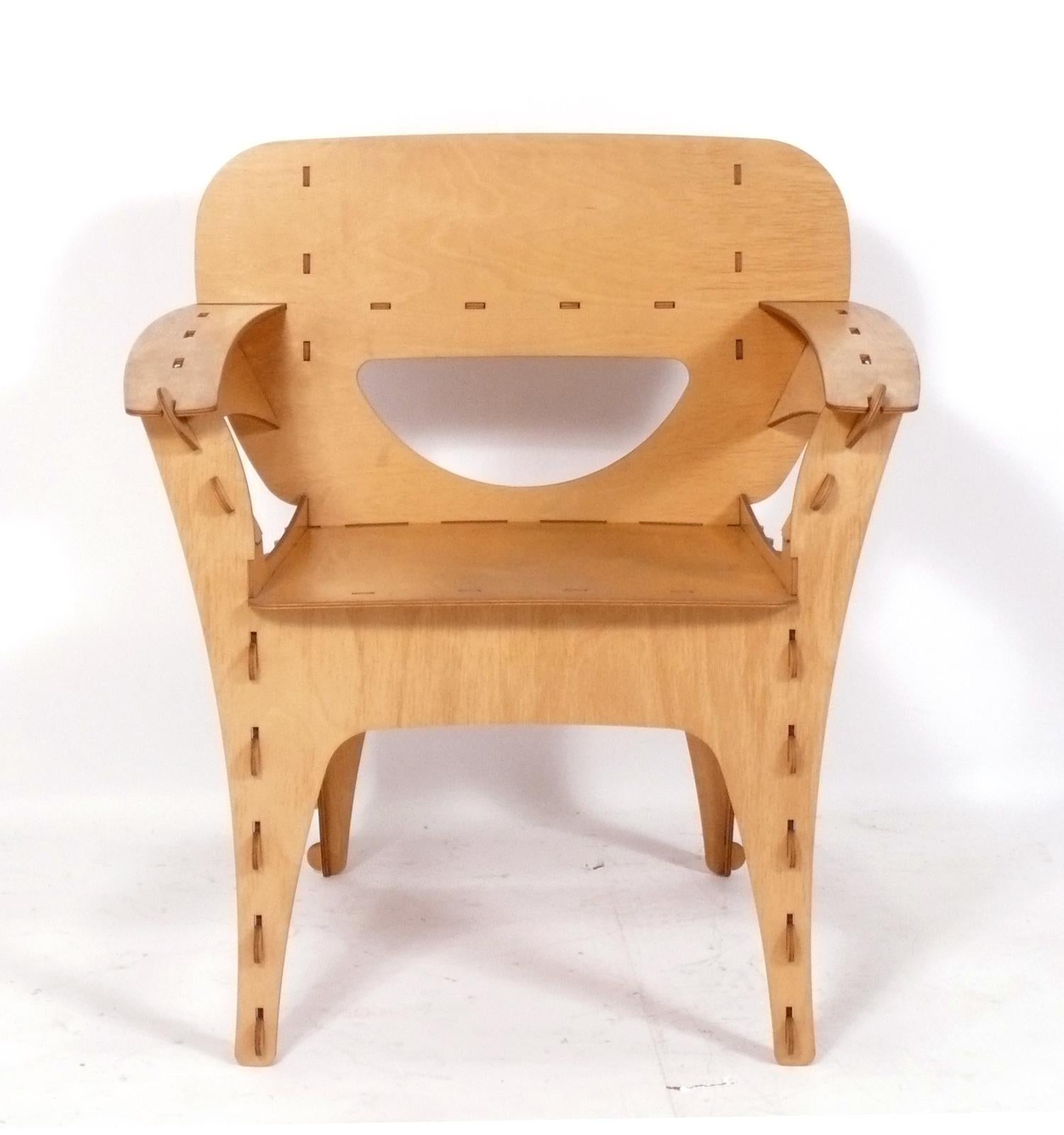 Sculptural plywood puzzle lounge chair, designed by David Kawecki, American, circa 1990s. This sculptural lounge chair retains its warm original patina.