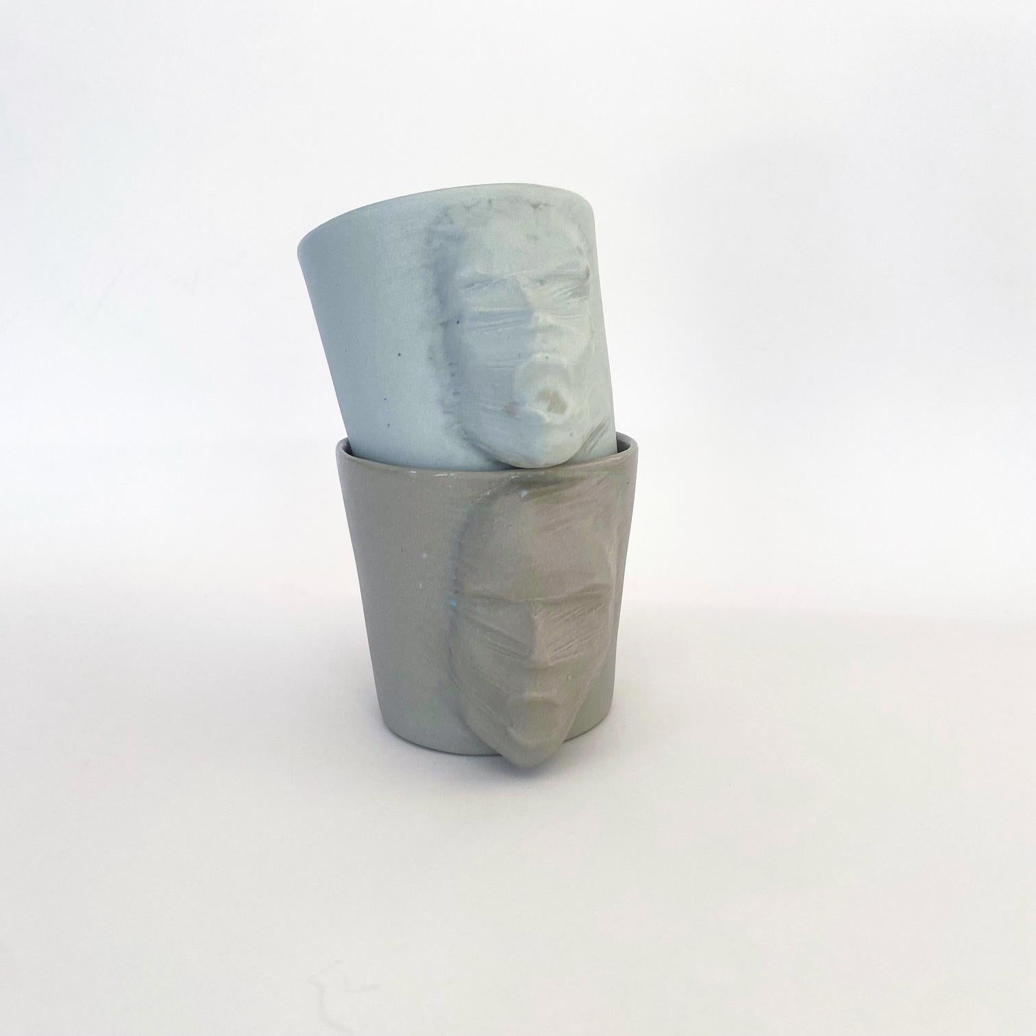 A set of 2 sculptural porcelain cups handmade by the ceramic artist Hulya Sozer. 
Food safe glaze.
Dishwasher safe.

Height: 6cm / Depth: 8cm / Diameter: 6cm
Volume: 100ml
Set includes 2 porcelain cups of 100ml

* Colors may slightly vary due to