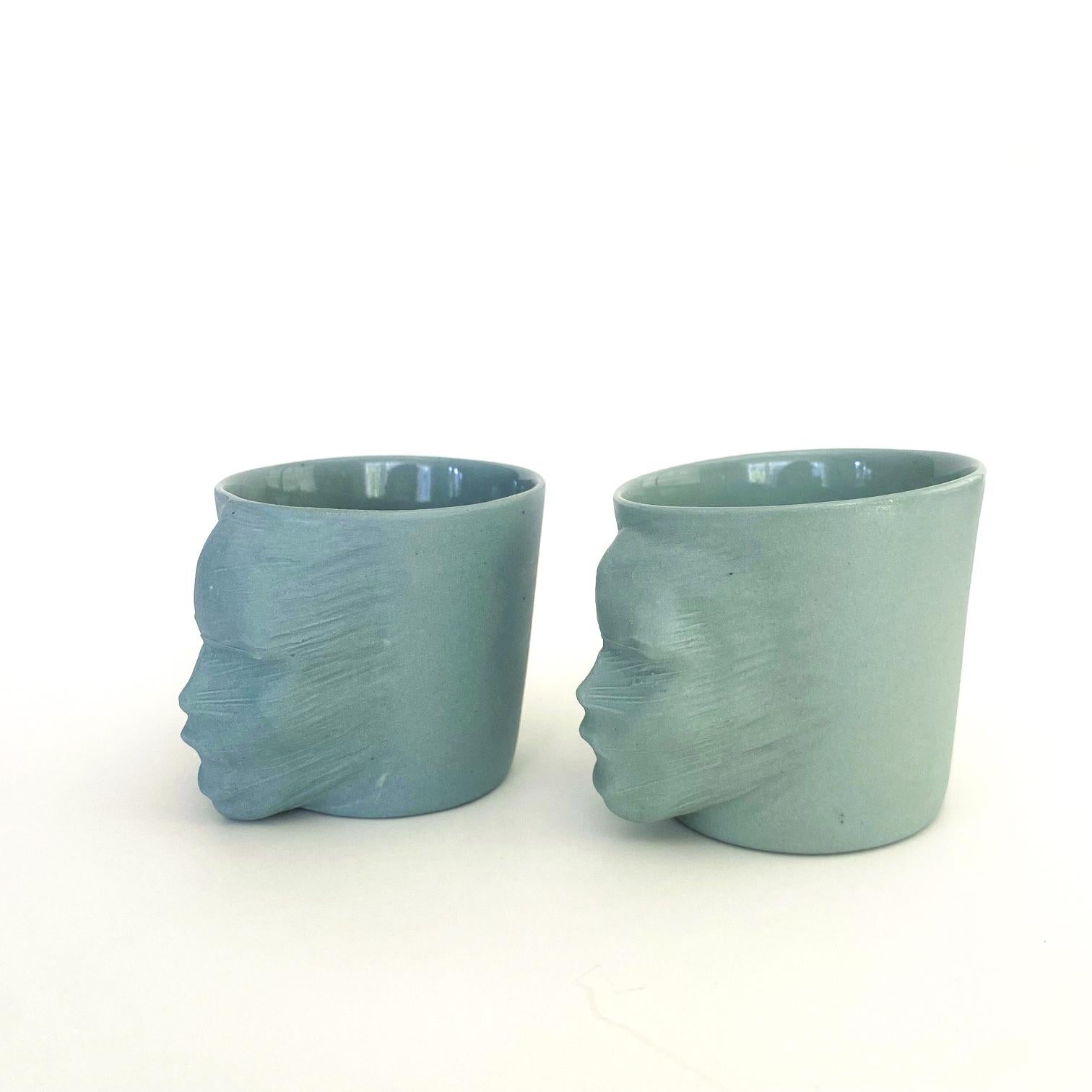 A set of 2 sculptural porcelain cups handmade by the ceramic artist Hulya Sozer. 
Food safe glaze.
Dishwasher safe.

Height: 6cm / Depth: 8cm / Diameter: 6cm
Volume: 100ml
Set includes 2 porcelain cups of 100ml

* Colors may slightly vary due to