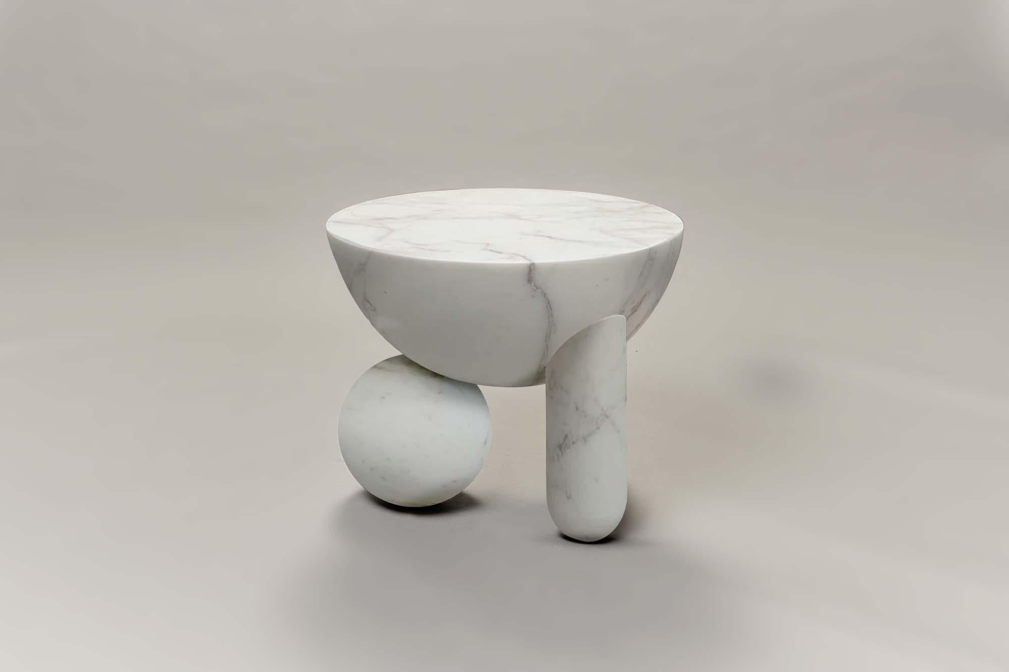 Profiterole small coffee table is 3D milled from calacatta oro marble, supported by round dessert-like spheres and semi-cupped legs which support a rounded top. The coffee table also comes in white carrara marble and black nero marquina, in either