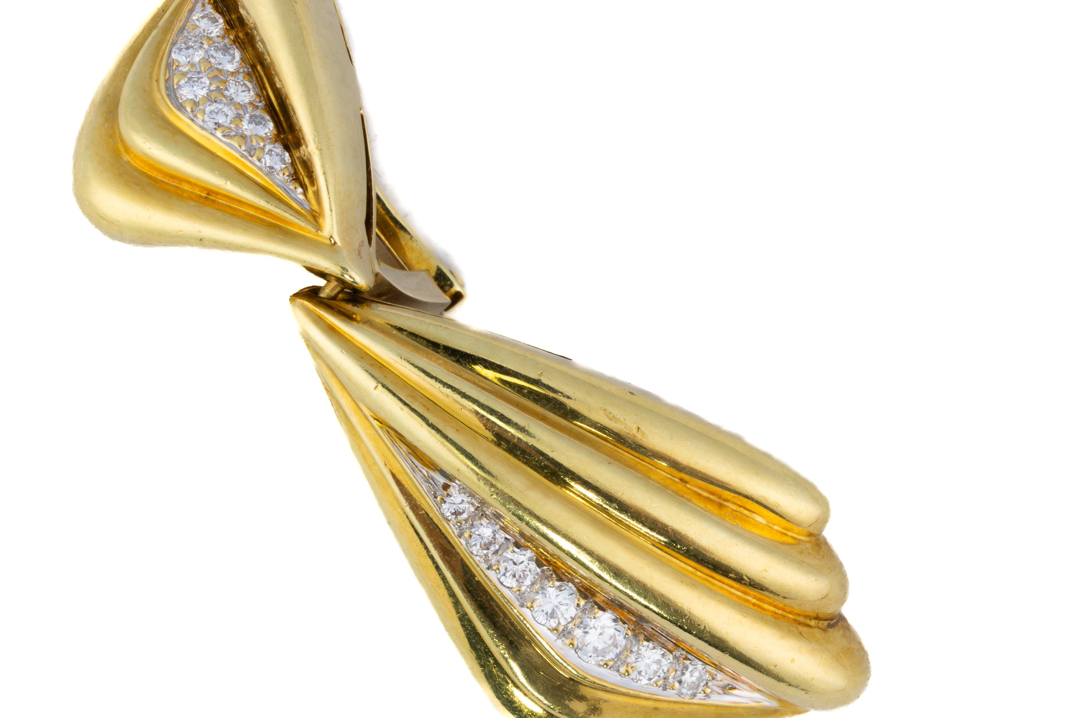 Sculptural Retro Diamond Fan Drop Earrings

Description:
These bold and sculptural earrings showcase a dynamic fan-like silhouette with dramatic folds and contours, accented by a tapered channel of round brilliant diamonds. The high-polished finish