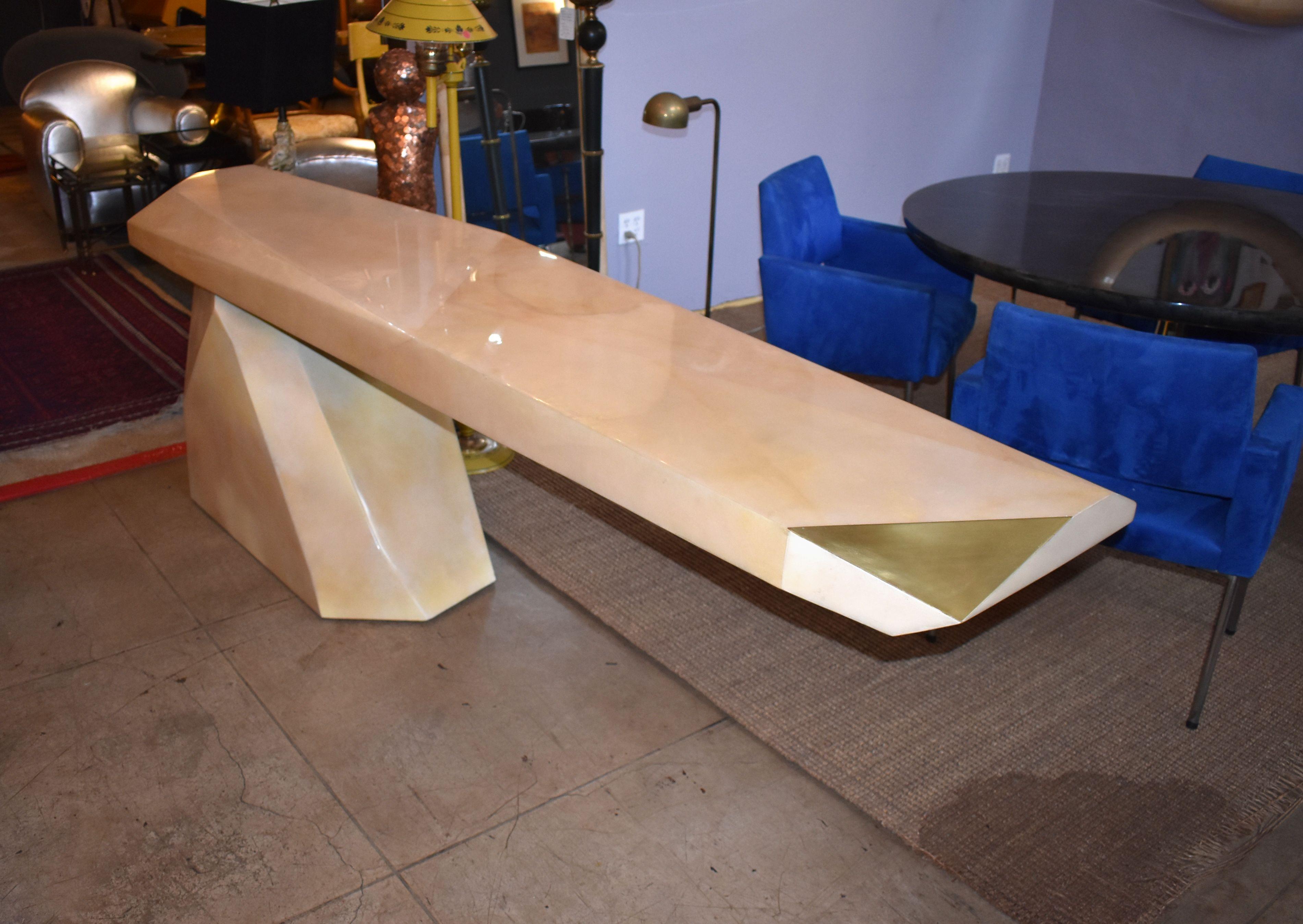 A fantastic sculptural cover with goatskin and brass detail top console table. Base is painted. (Top console finish with High gloss polyester resin filled).