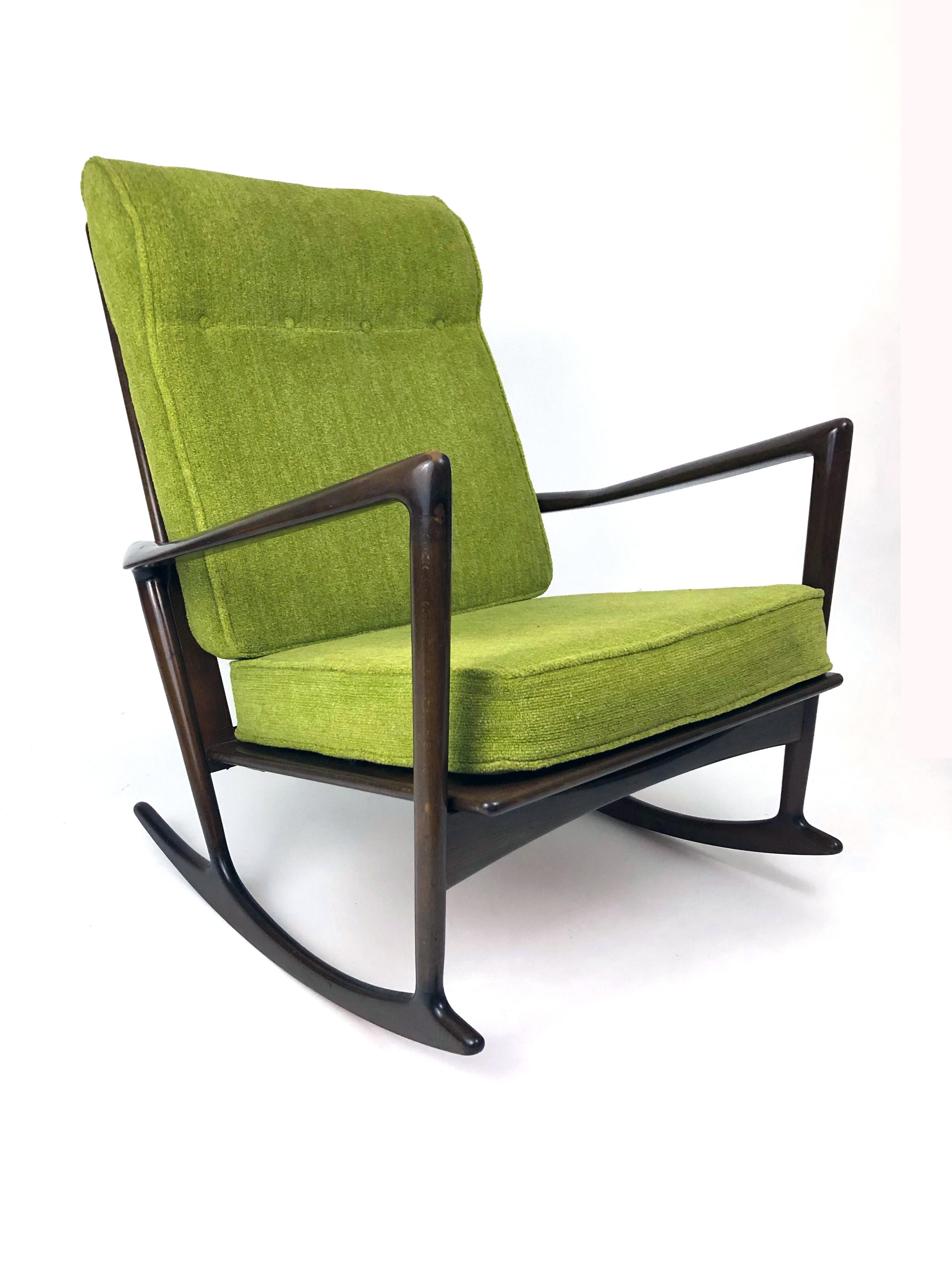 A dark walnut sculptural rocking chair designed by Ib Kofod-Larsen in 1962 for Christian Linnebergs Møbelfabrik. Imported to the U.S. by Selig.