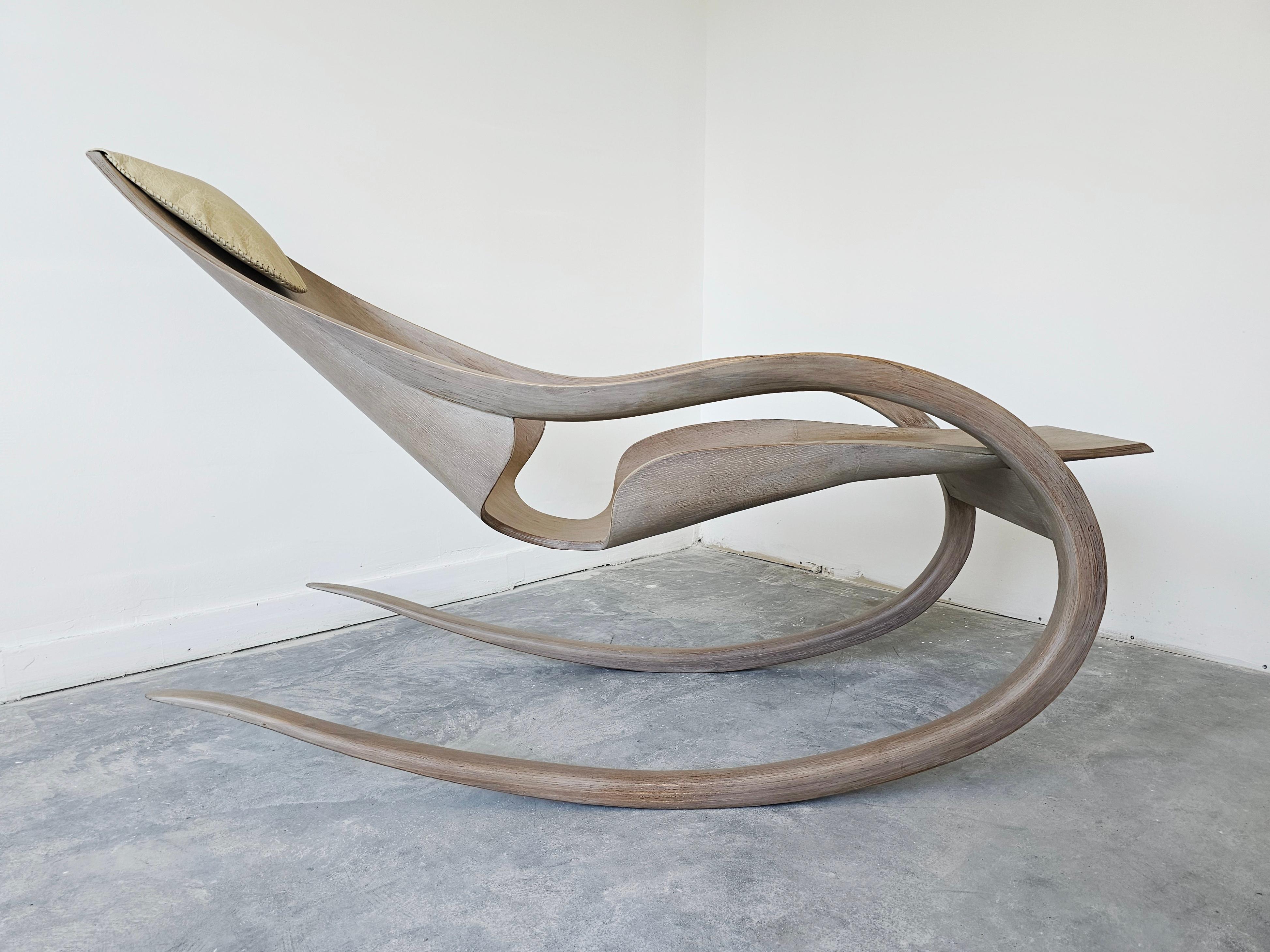 Breathtaking Sculptural Rocking Chair done in molded Ash plywood featuring mesmerizing organic lines, resembling the work of the American artist and designer Wendell Castle. The chair is used in the lying condition. It is a unique, handmade