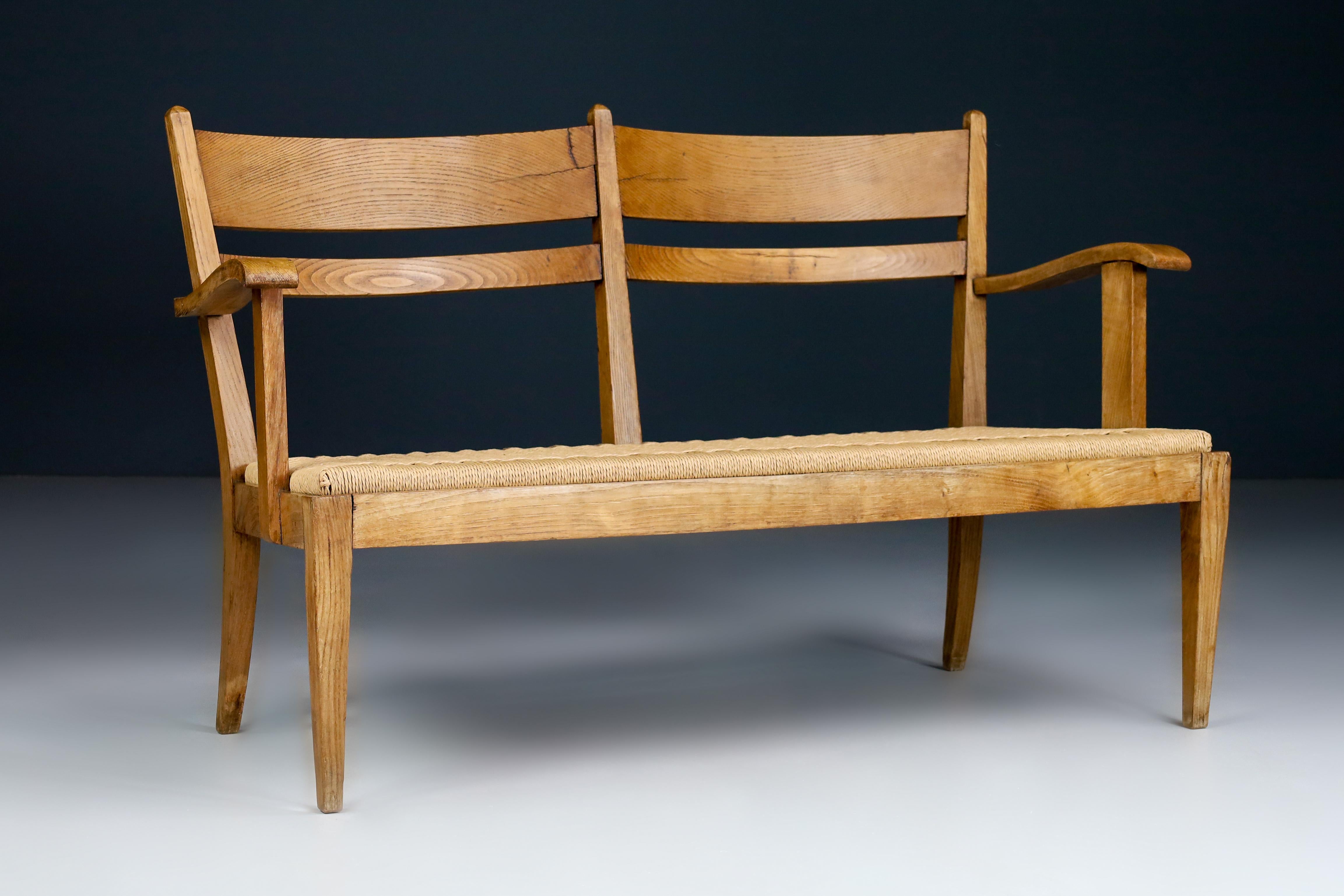 Sculptural rope and oak settee or bench, France 1950s

Sculptural settee or bench executed in rope and solid oak and made and designed in France in the 50s. Rustic yet elegant due to the sleek tapered legs that reveal a certain level of