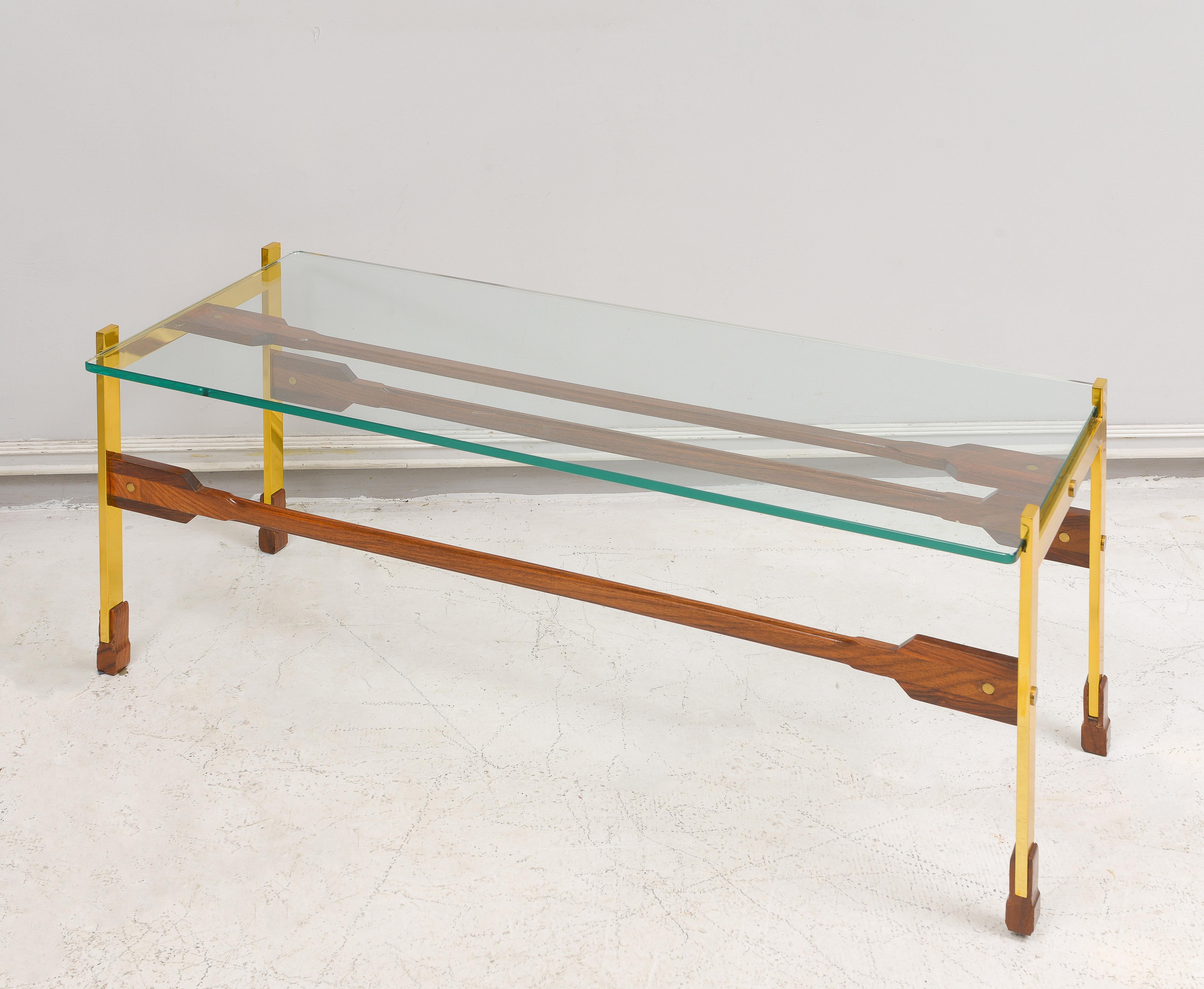 Sculptural rosewood and brass coffee table.