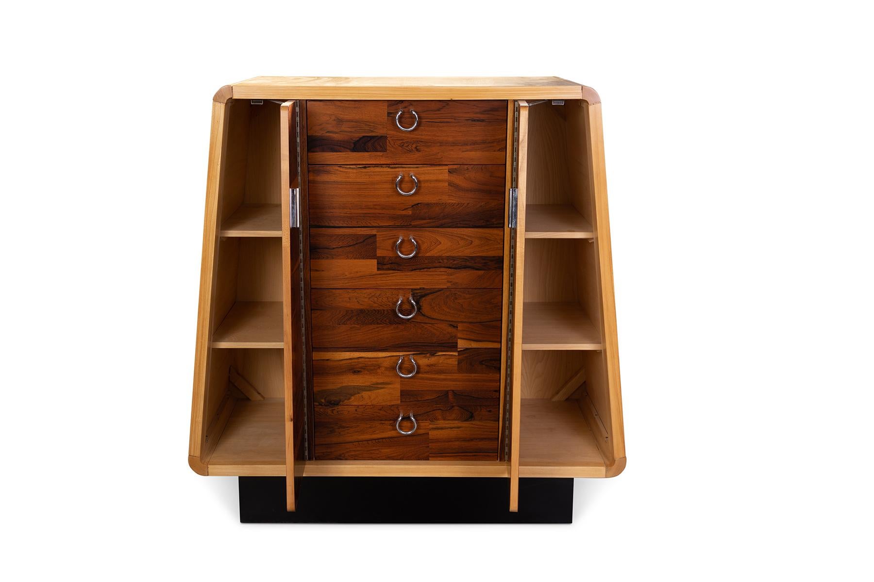 Rosewood, maple and polished steel highboy from Canada circa early 1970s. This sculptural example has been newly and masterfully refinished. It has 6 drawers and two doors with interior storage.