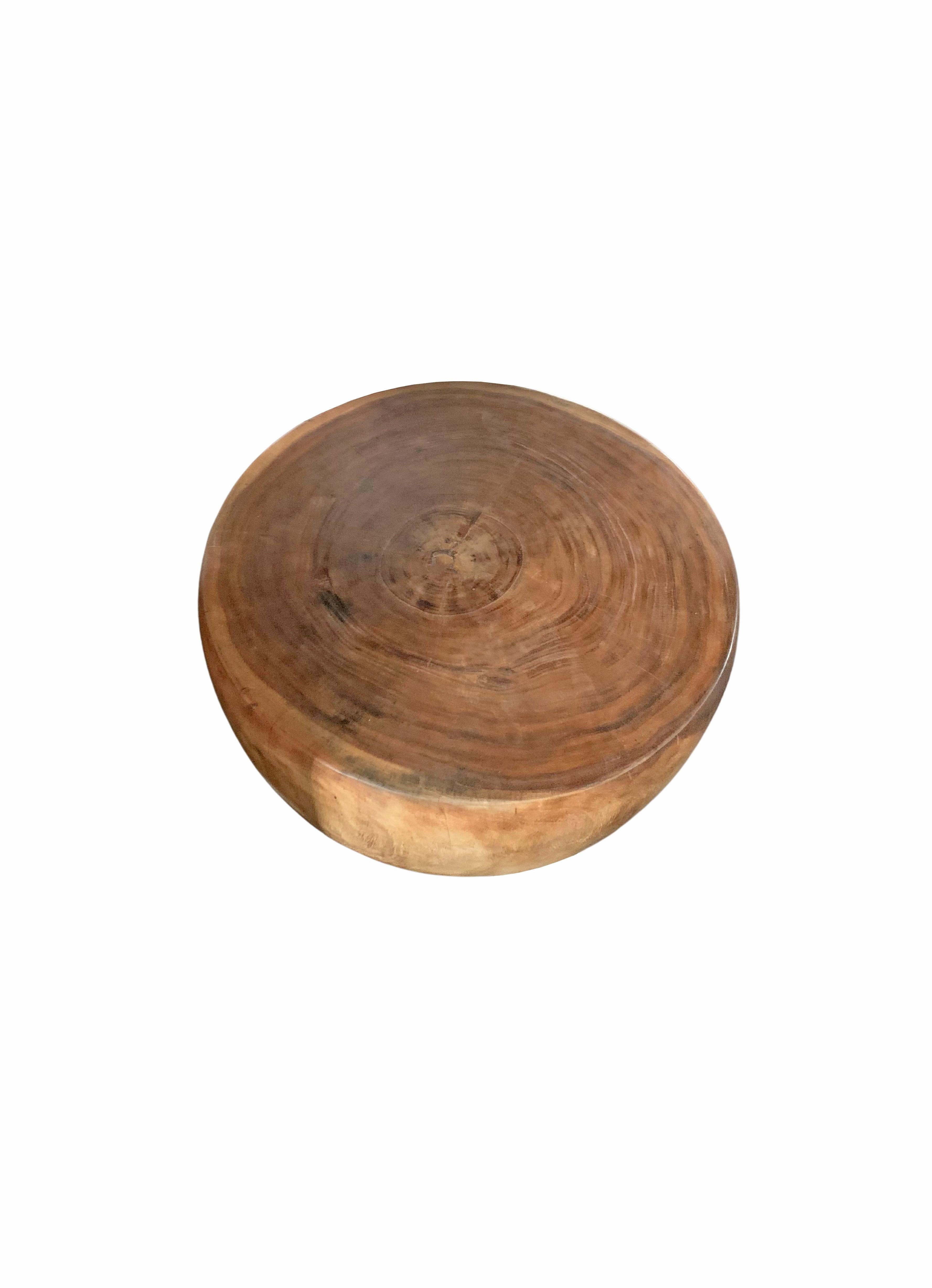 A wonderfully sculptural round side table. Its neutral pigment and subtle wood texture makes it perfect for any space. A uniquely sculptural and versatile piece certain to invoke conversation. This table was crafted from solid mango wood and has a