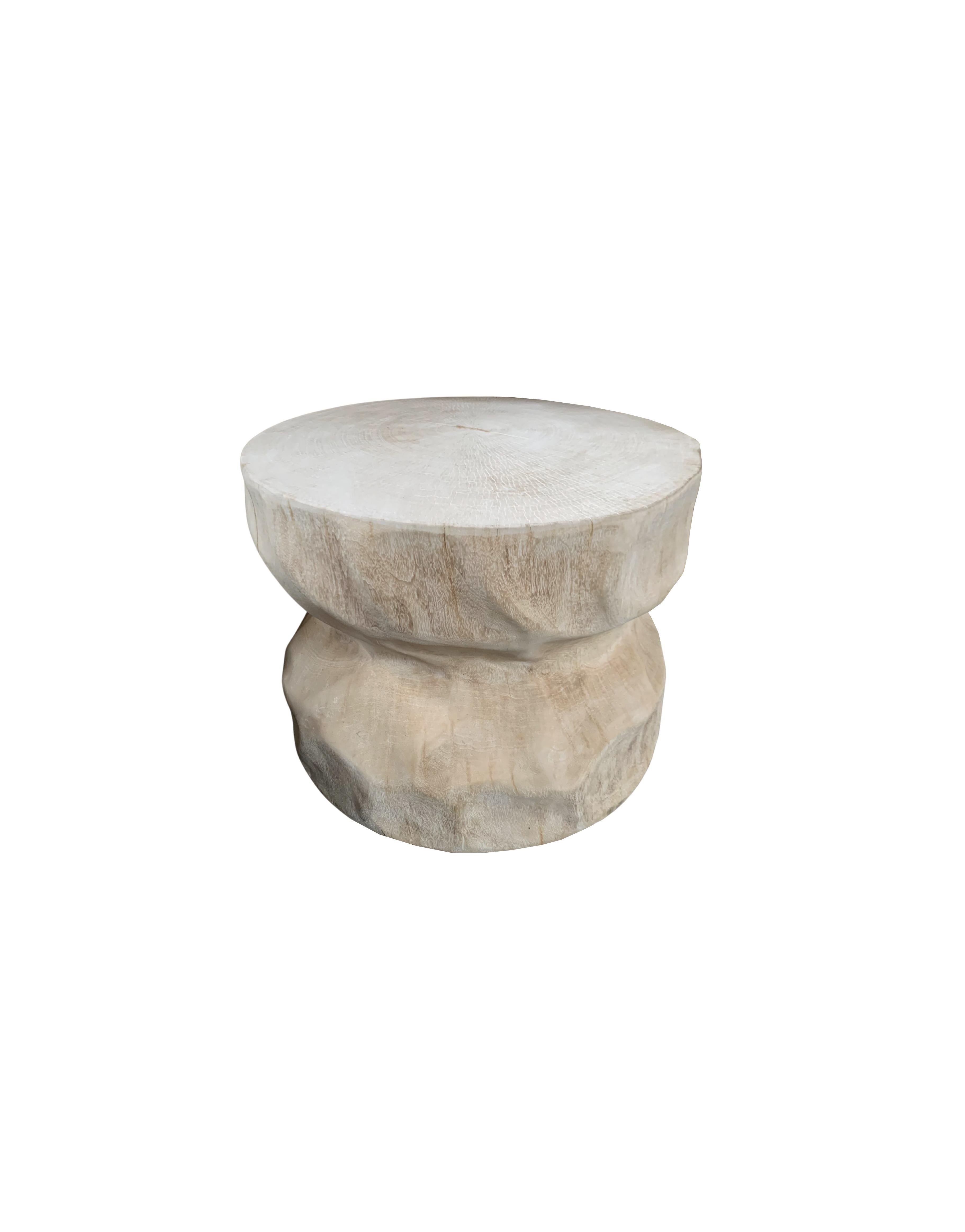 This wonderfully sculptural round side table features a ribbed & spiral pattern along its sides. The table's neutral pigment makes it perfect for any space. A uniquely sculptural and versatile piece certain to invoke conversation. It was crafted