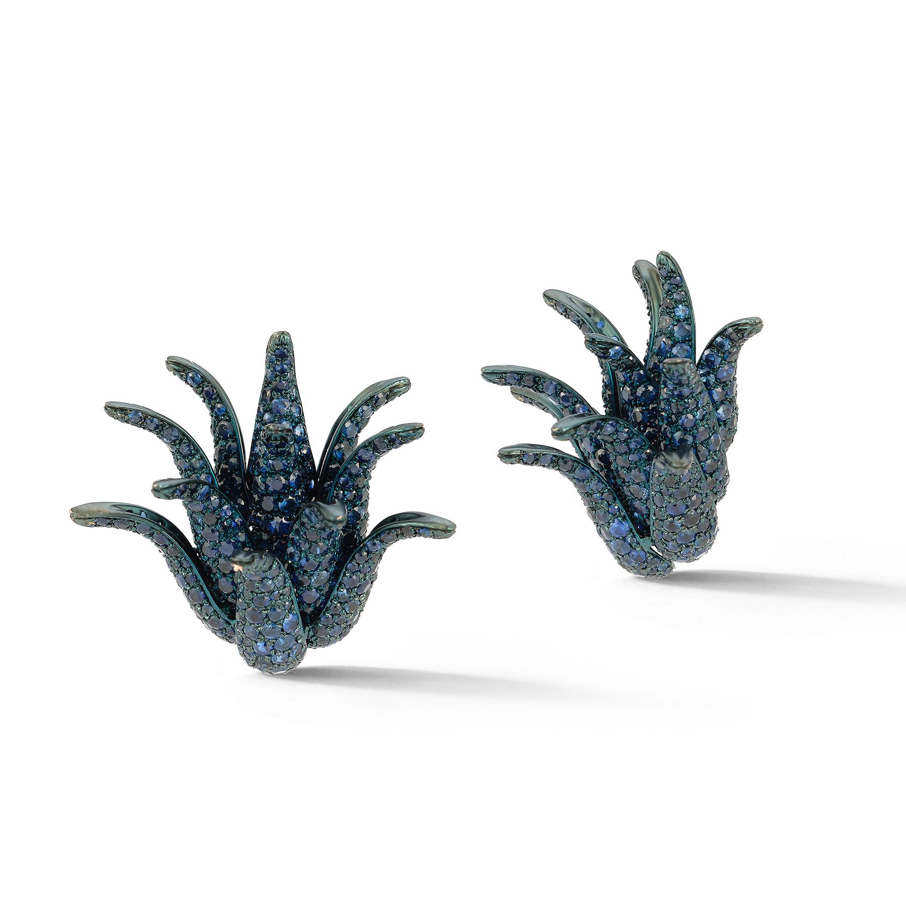 Sculptural Sapphire Cluster Earrings

Description:
Strikingly sculptural and bold, these sapphire earrings present an organic form reminiscent of curling petals or abstract sea flora. Crafted in blackened gold, the dramatic silhouette is encrusted