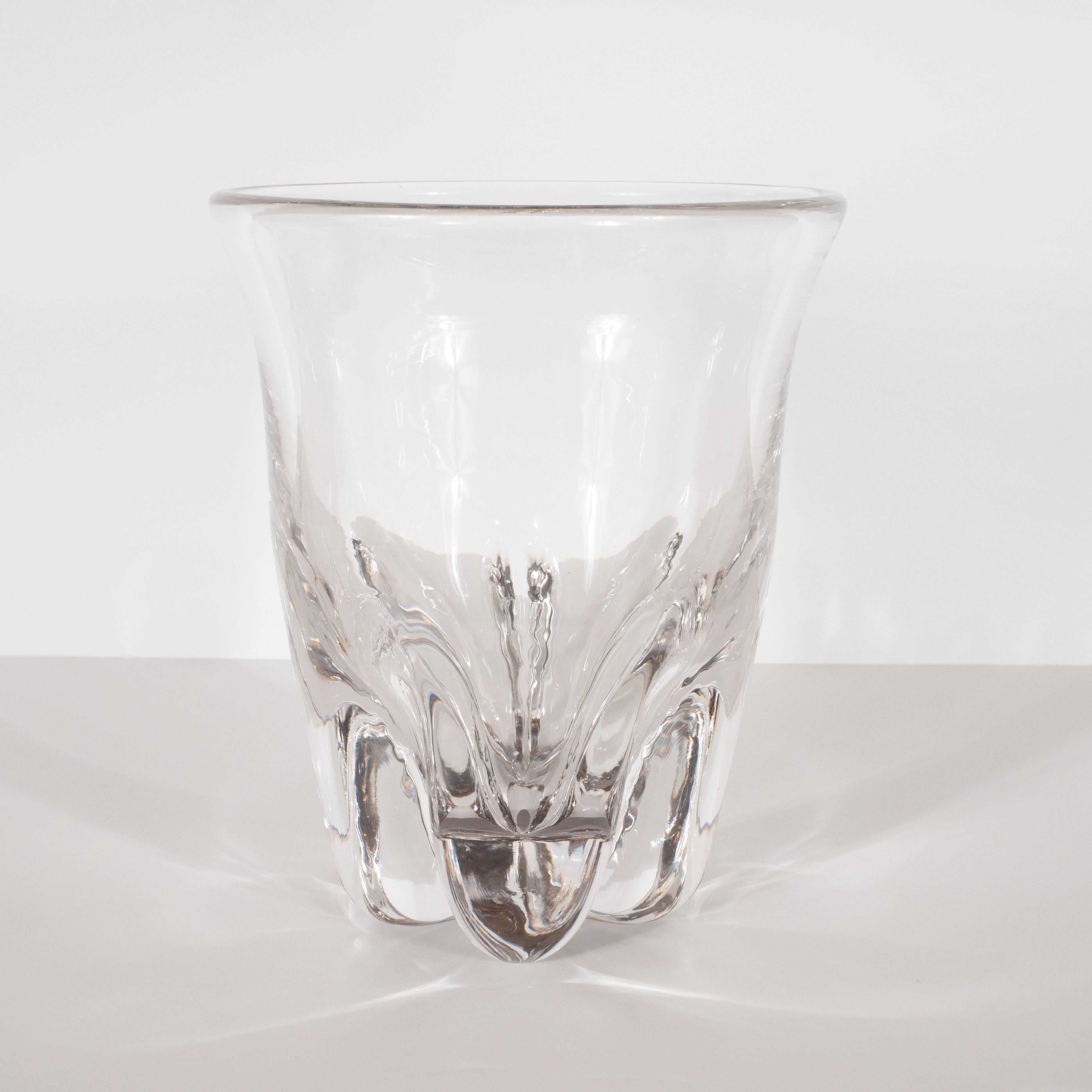 This sculptural and dramatic Mid-Century Modern glass vase was realized in Sweden, circa 1960. It features five robust curvilinear tear drop feet with deeply recessed channels separating them. The cylindrical body flares subtly at the mouth. This