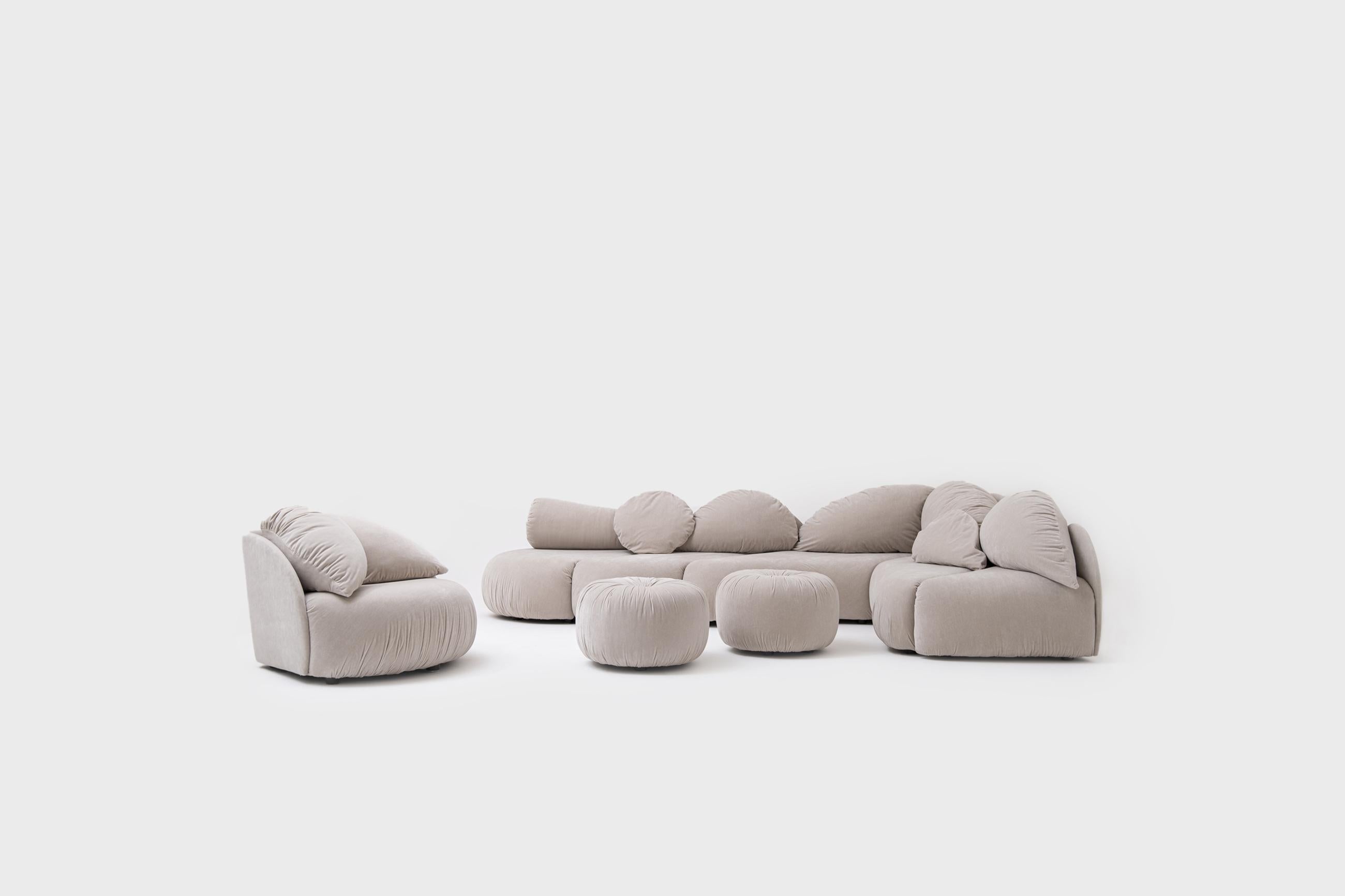 Stunning large sectional sofa group by Wiener Werstätten, 1970. Very distinctive design and extraordinary shapes. The sofa group consists 5 elements, 2 poufs and a loose chair, all newly upholstered in a High quality sand colored velvet. Unique