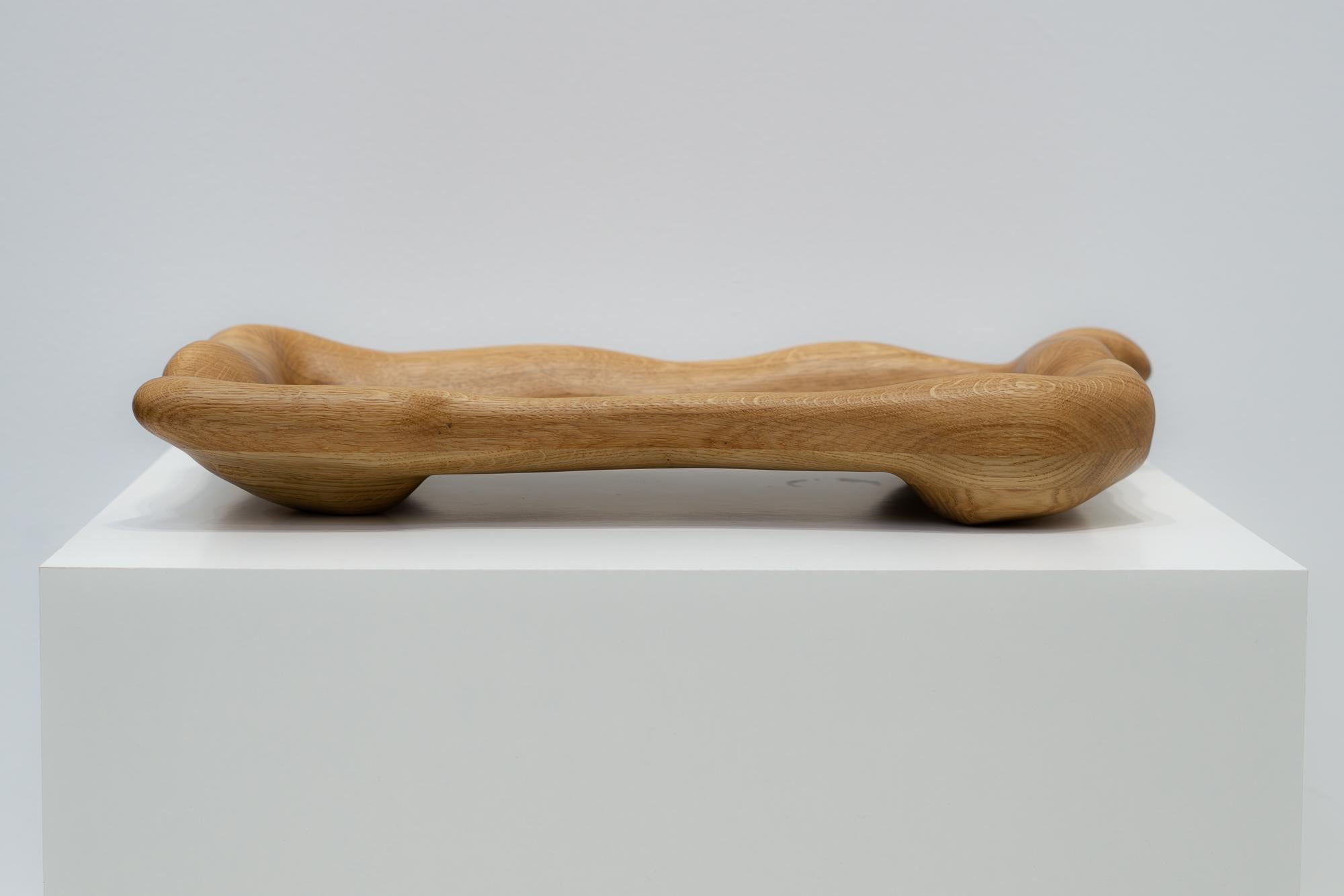 The serving tray is shaped using various hand tools, making each piece unique with its own distinctive wood grain. It is made from high-quality oak wood and finished with a hardwax oil.

The serving tray can be customized according to your