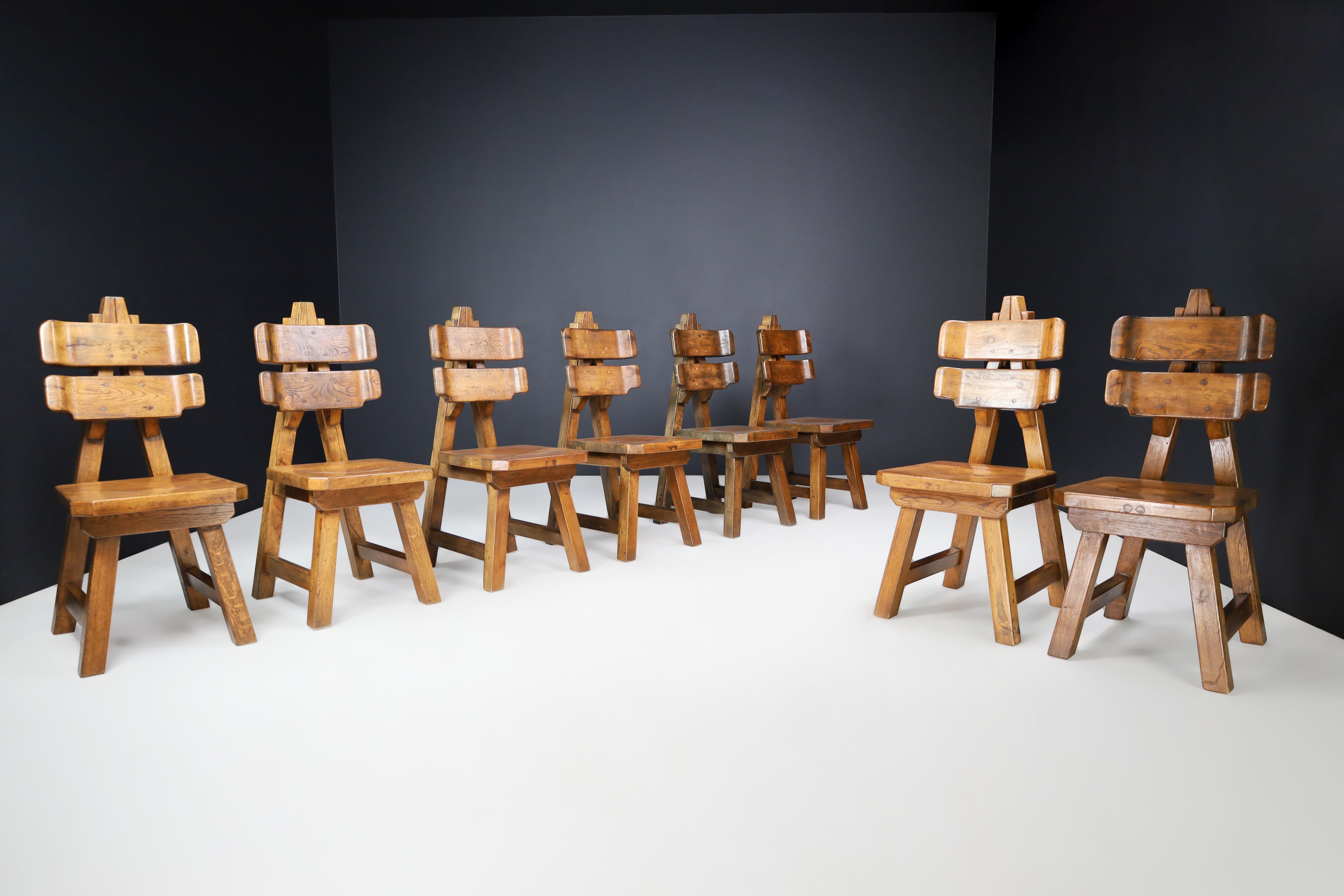 Sculptural Set of Eight Brutalist Dining Chairs in Solid Oak, France, 1960s

These eight dining chairs are a rare find from France, made in the late 1960s. The design is notable for its curved backrest and rounded, carved seat. The triangular back