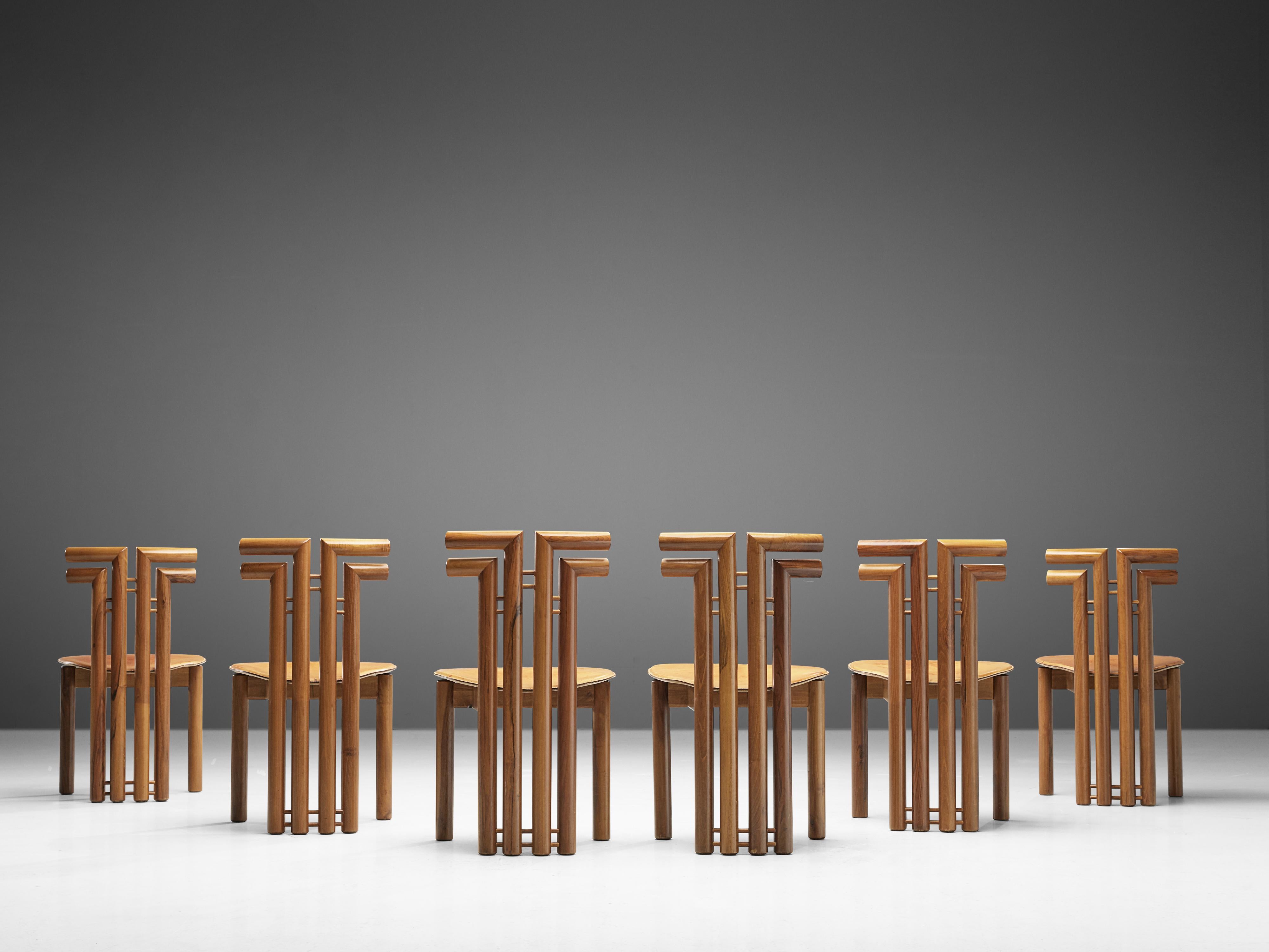 Set of six dining chairs, Italian walnut and cognac leather, Italy, 1970s.

Set of sculptural chairs that feature wonderful backrests, consisting of four legs that form out to the side, which creates a sculptural appearance. The front legs are