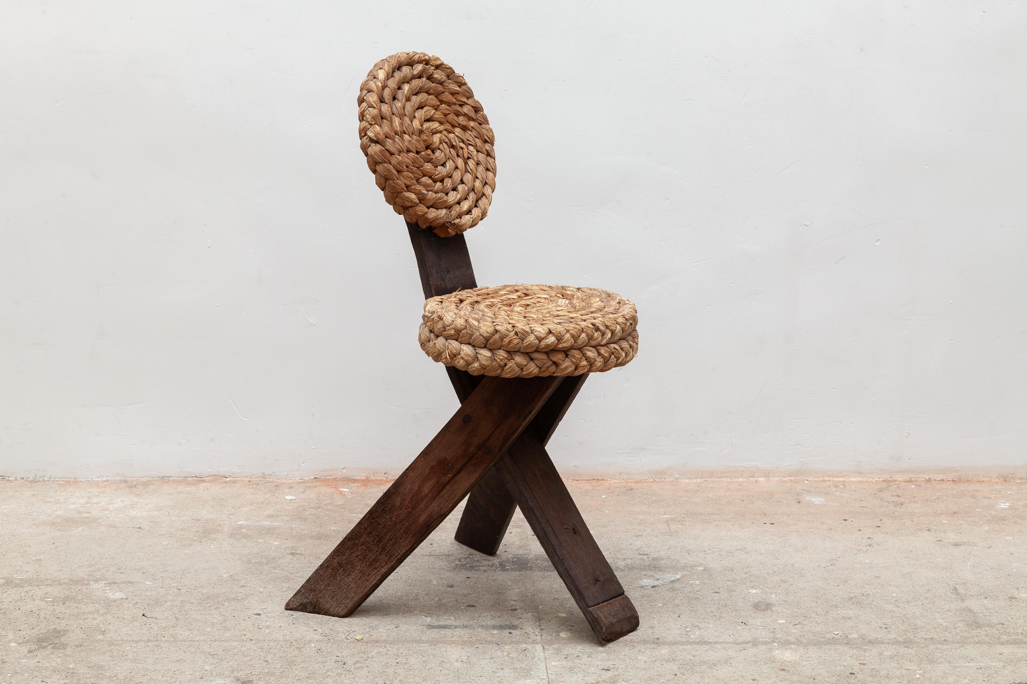 Sculptural side chair were created by the French designers Adrien Audoux and Frida Minet. The three flat legs are made of dark oak the wood was originally used for wine barrels. Thick braids arranged in circles create a vivid pattern. 
Adrien Audoux