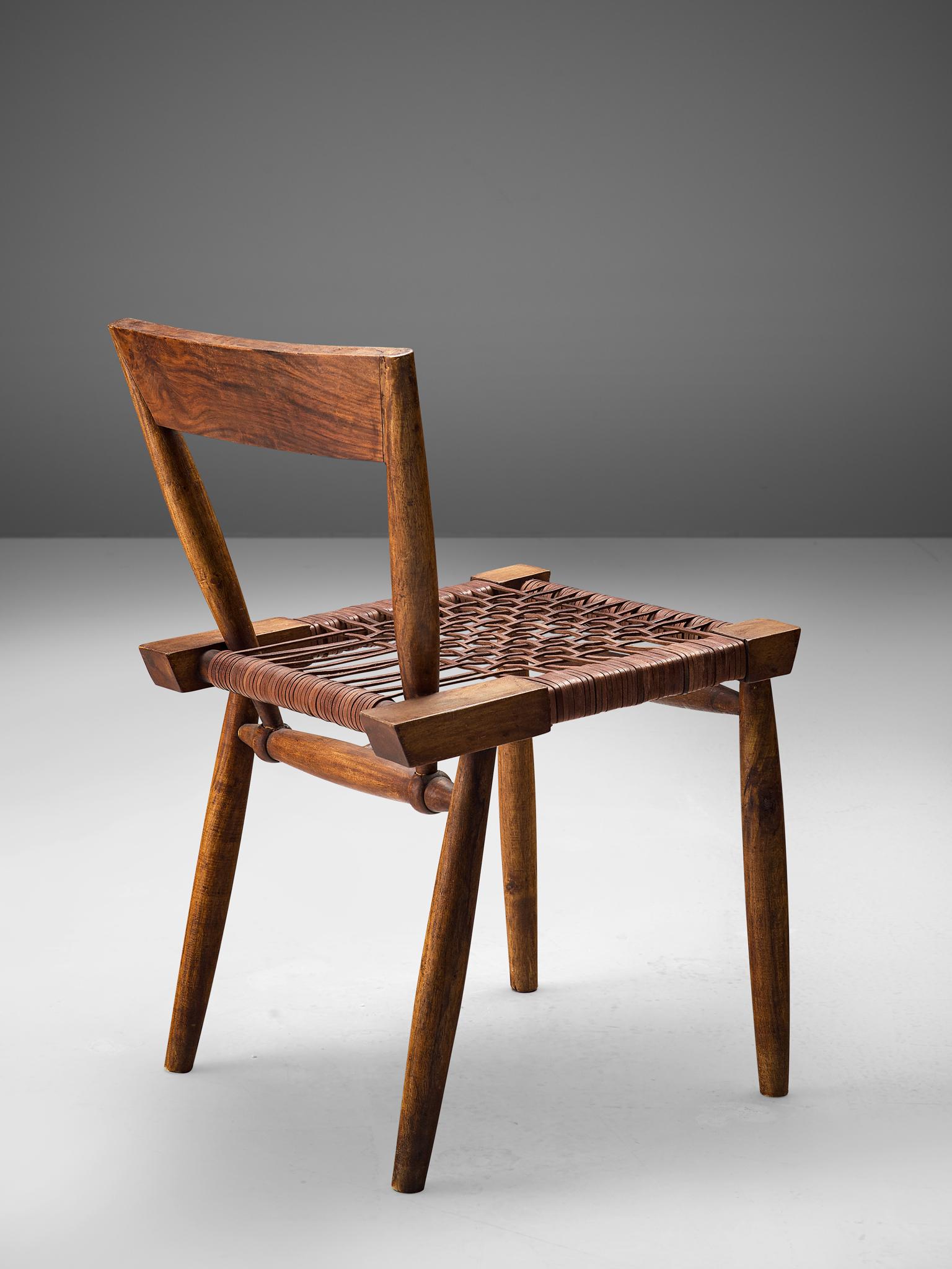 Side chair, leather and hardwood, United States, 1950s

This American handcrafted chair is as sculptural as it can get. A combination of sturdy shapes and elegant, slender lines is well-considered. The walnut frame consists of a subtle curved