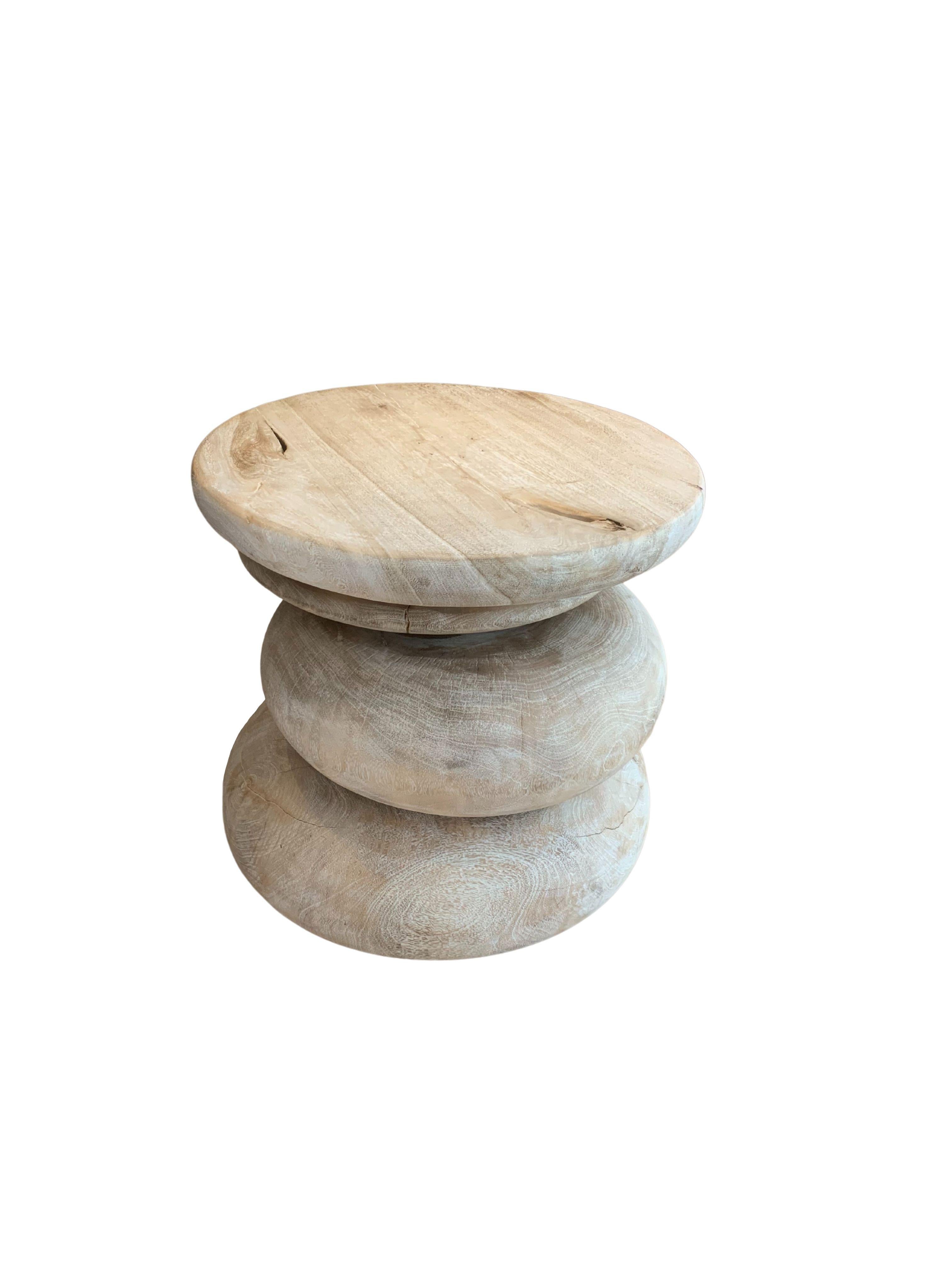 A wonderfully sculptural side table resembling a pile a river stones in a washed out finish. Its neutral pigment and subtle wood texture makes it perfect for any space. A uniquely sculptural and versatile piece certain to invoke conversation. This