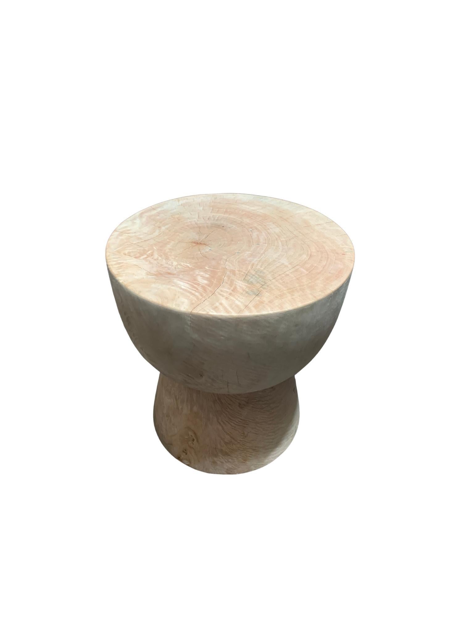 A wonderfully sculptural round side table. Its cream/white pigment was achieved through a bleaching process creating both a wonderful colour and effect. Its neutral pigment and subtle wood texture makes it perfect for any space. A uniquely
