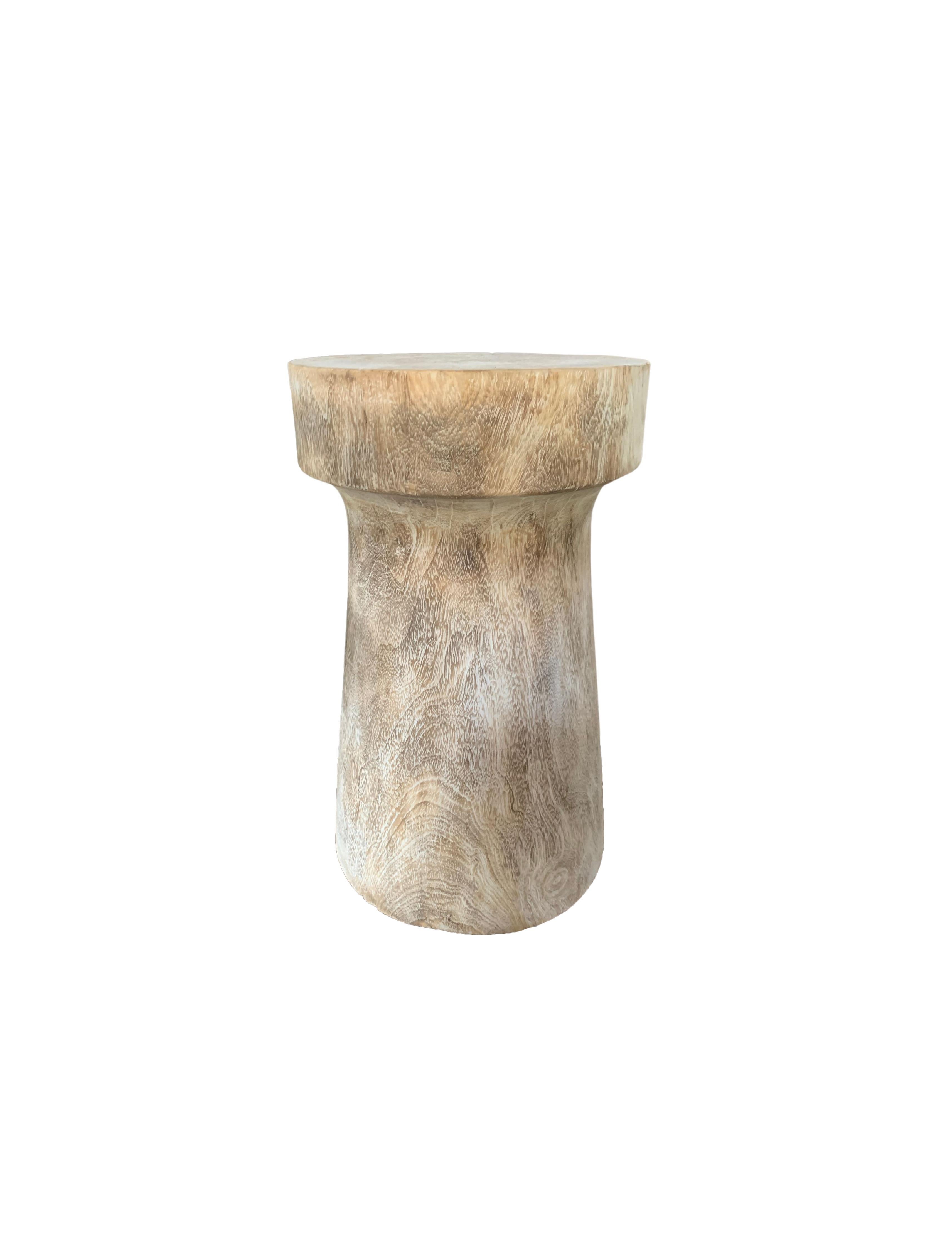 A wonderfully sculptural round side table. Its cream/white pigment was achieved through a bleaching process creating both a wonderful colour and effect. Its neutral pigment and subtle wood texture makes it perfect for any space. A uniquely