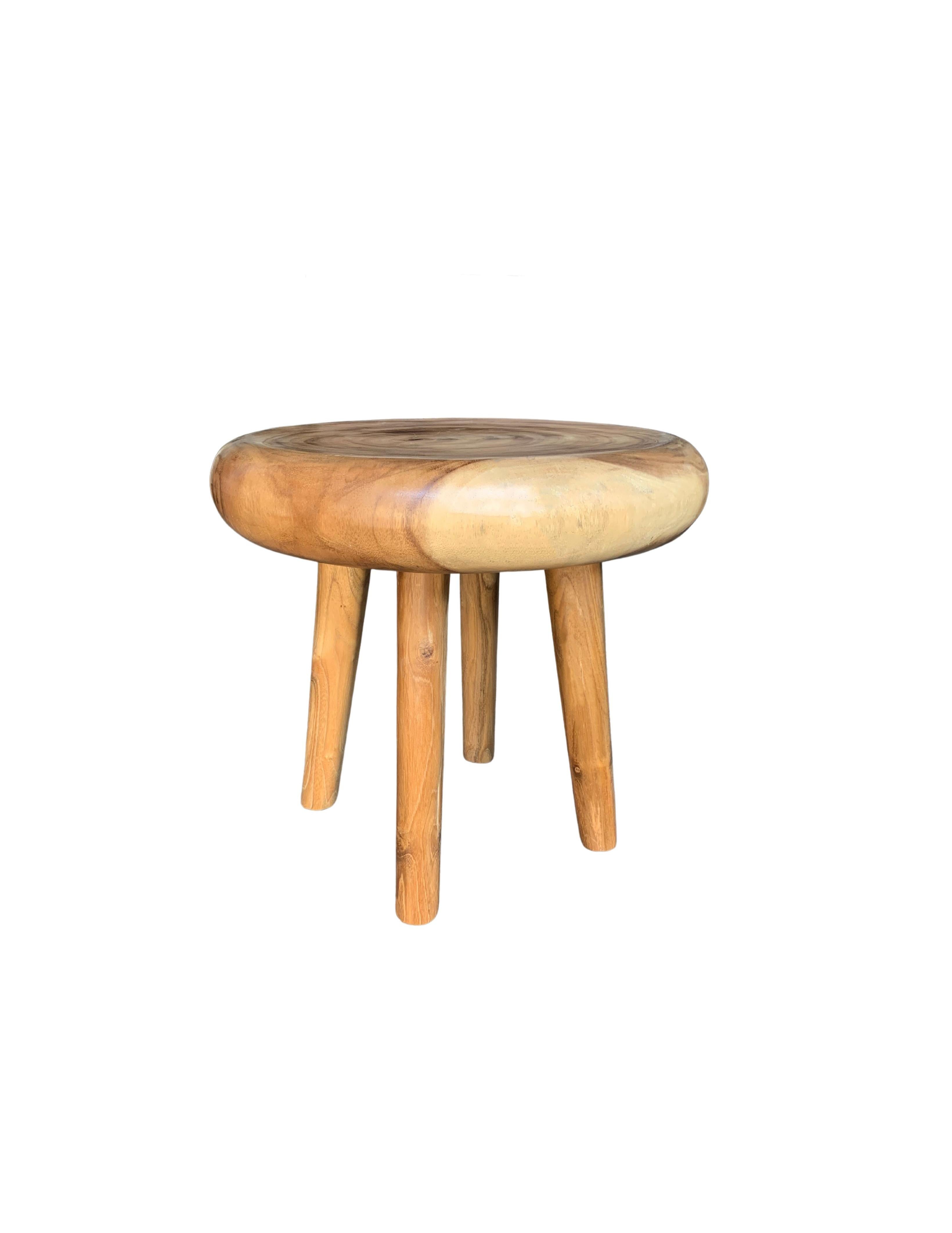 A wonderfully sculptural round side table with narrowly proportioned legs. Its neutral pigment and subtle wood texture makes it perfect for any space. A uniquely sculptural and versatile piece certain to invoke conversation. This table was crafted
