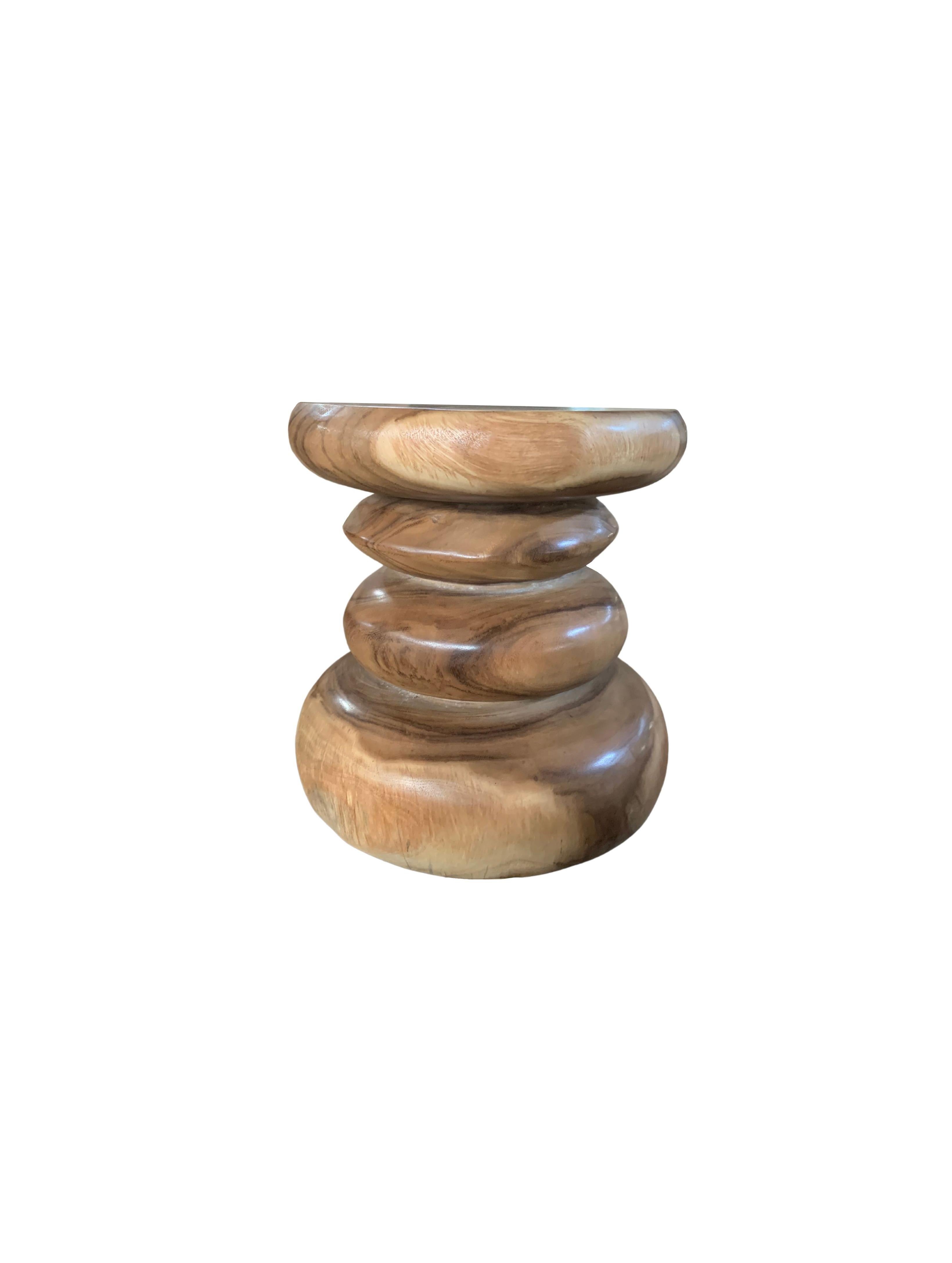 A wonderfully sculptural side table resembling a pile a river stones. Its neutral pigment and subtle wood texture makes it perfect for any space. A uniquely sculptural and versatile piece certain to invoke conversation. This table was crafted from