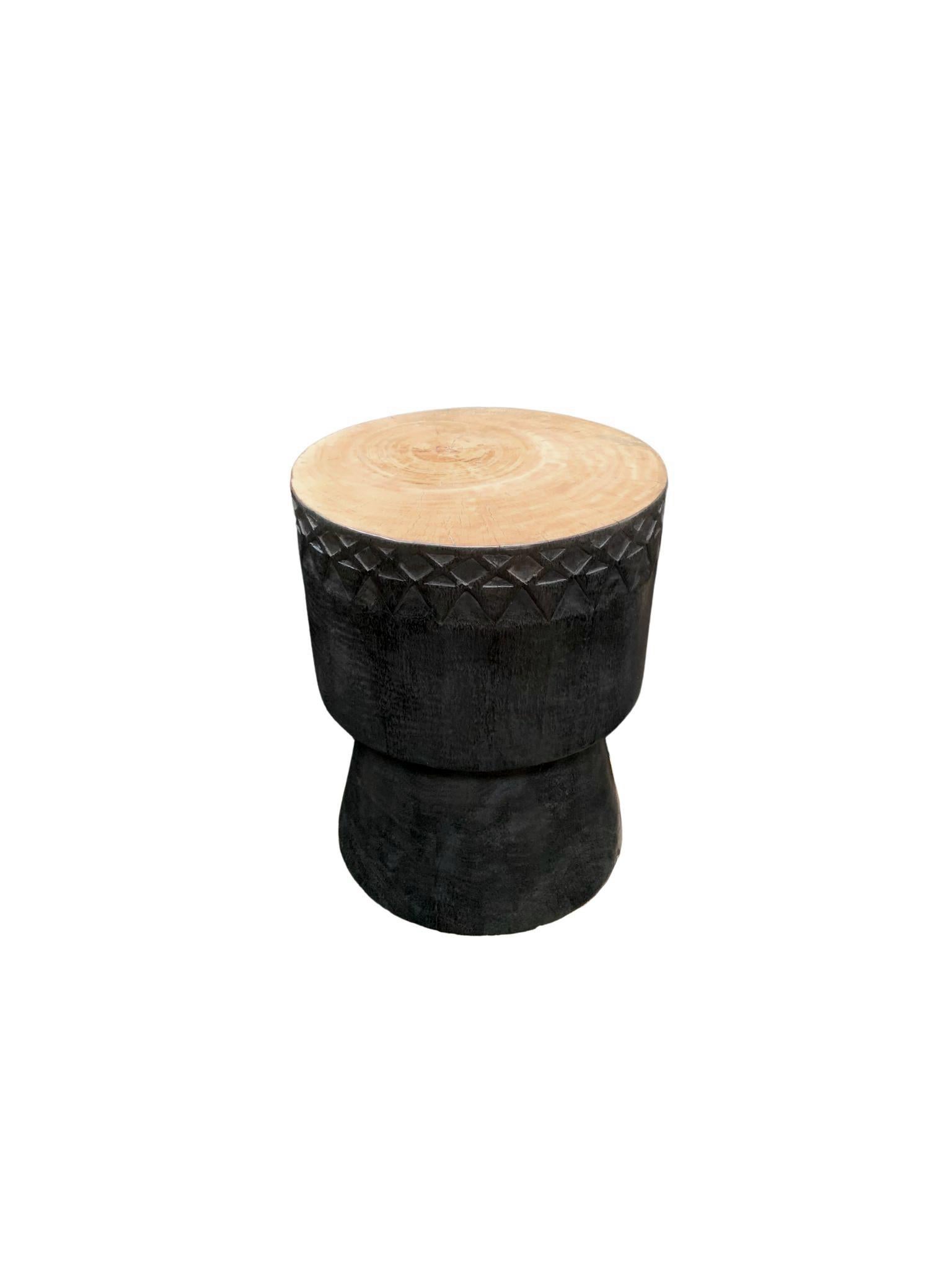 A wonderfully sculptural round side table. Its stark black pigment was achieved through burning the wood three times. Its cream/white pigment on the table top was achieved through a bleaching process creating both a wonderful colour and effect. This
