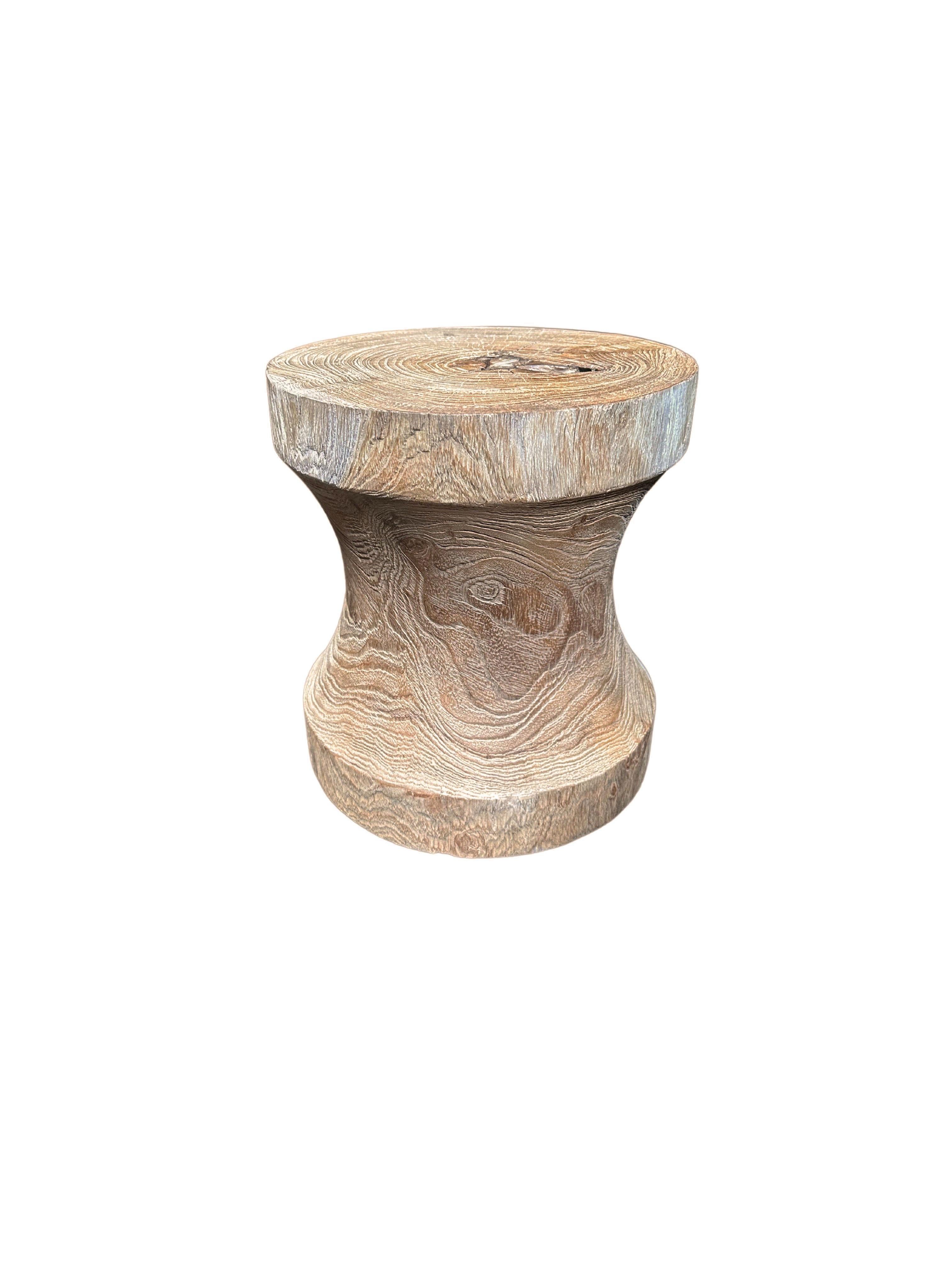 A wonderfully sculptural round side table in a natural finish. Its neutral pigment and wood texture makes it perfect for any space. Carved from a solid trunk of teak, the wood textures are brought to life. 

 