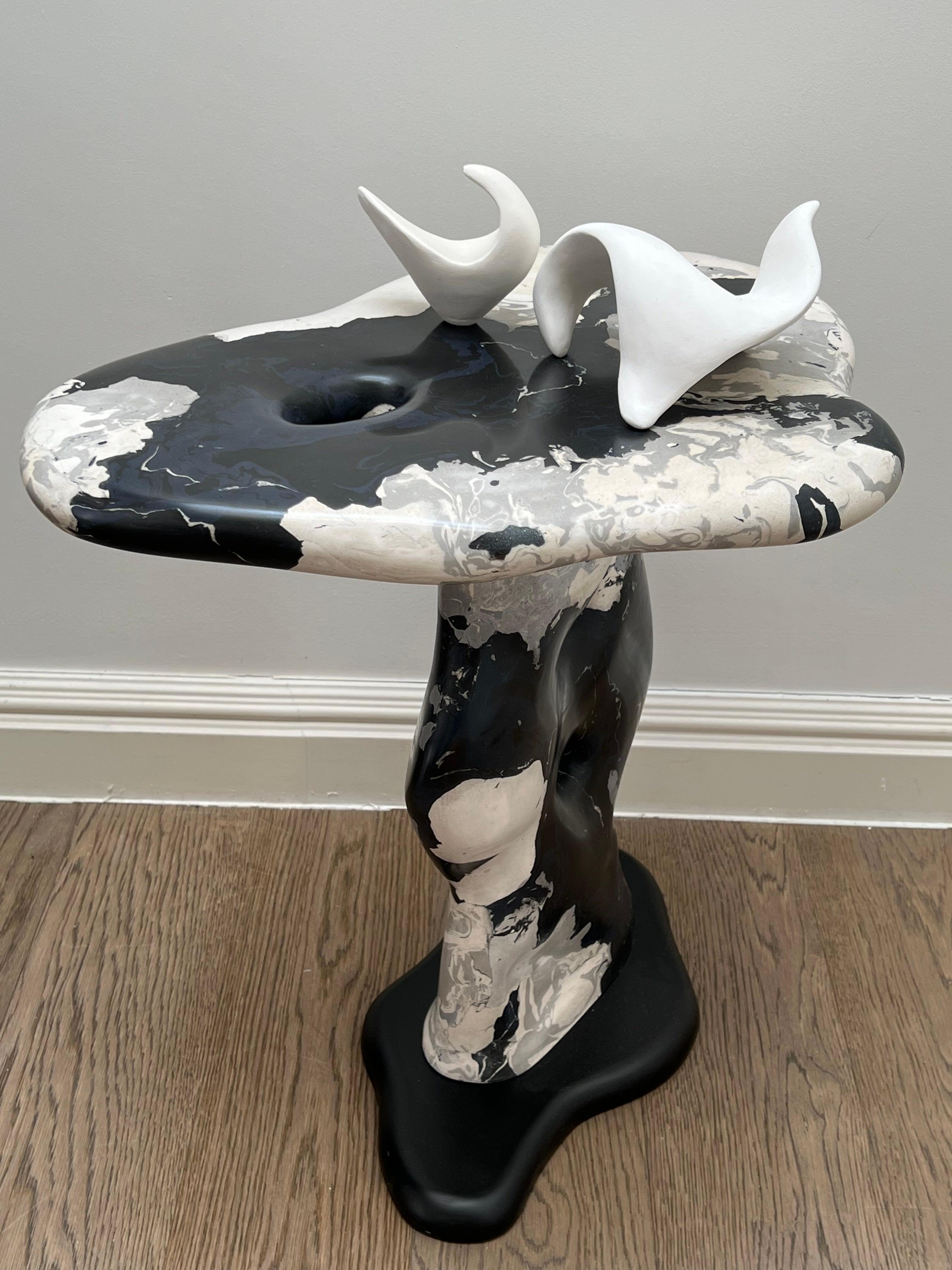 A striking sculptural side table, hand crafted in scagliola-made stone in a marbleised form. A lengthy process using natural pigments and composites to specific formula and whereby repeated sanding, filling and polishing take place. All by hand. The