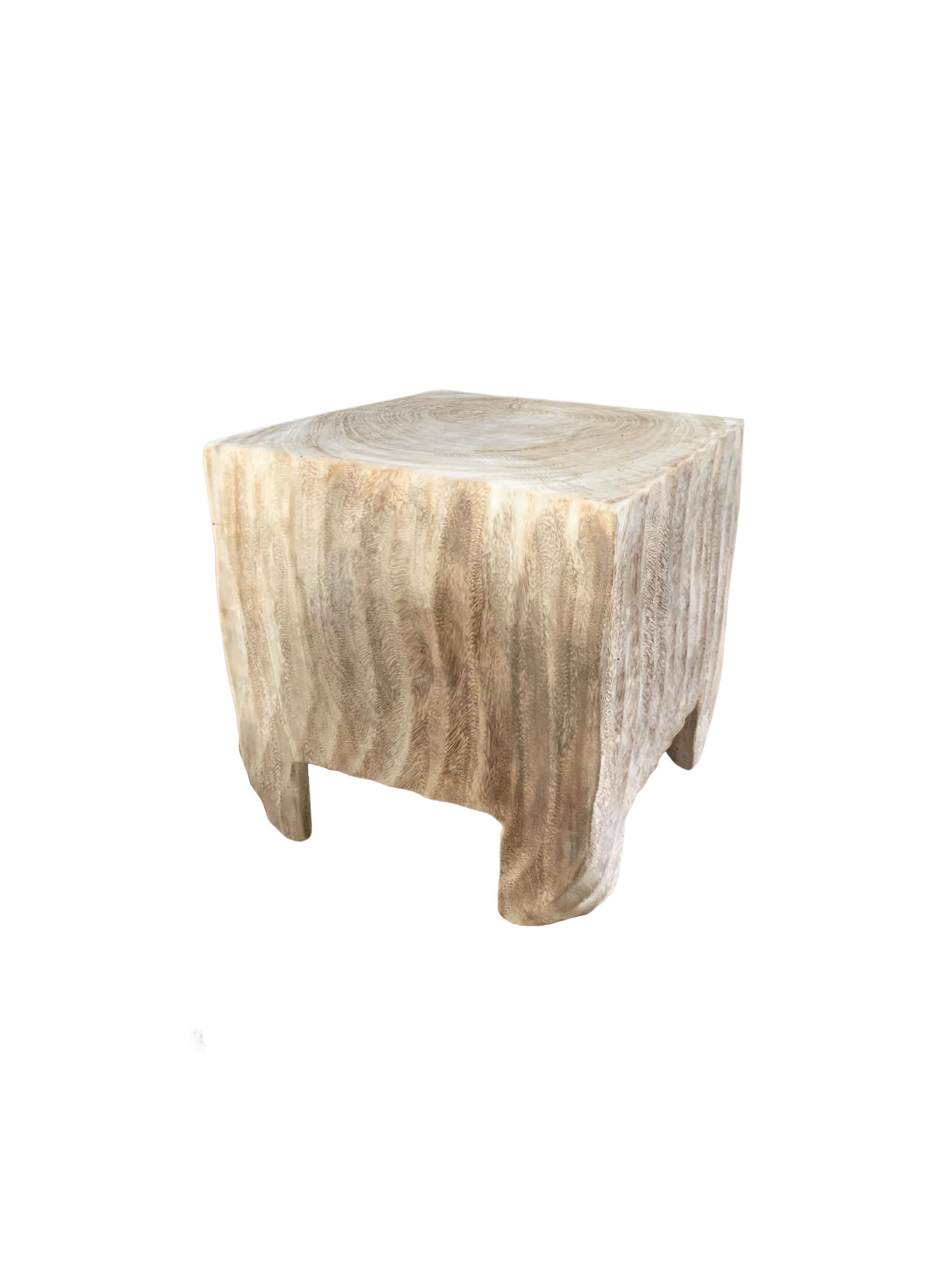 This wonderfully sculptural round side table features a ribbed pattern along its sides. The table's neutral pigment makes it perfect for any space. A uniquely sculptural and versatile piece certain to invoke conversation. It was crafted from a solid
