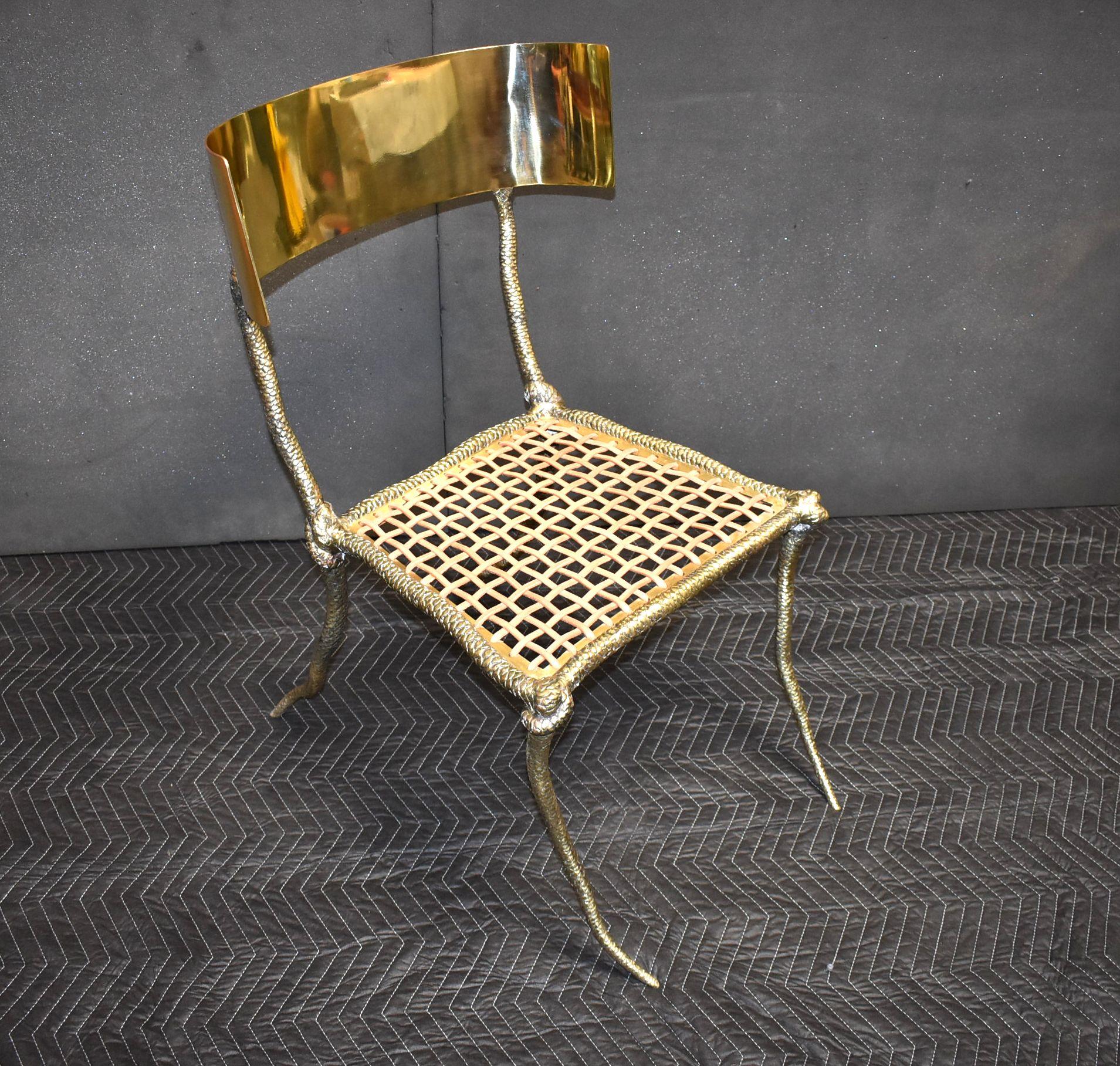 Solid brass sculptural side chair with leather strapping and curve back. 

Additional dimensions:
Width of curve back 21.50 inches
Width front seat 21 inches
Width back seat 18 inches
Depth from front to back legs 28.50 inches
Height seat