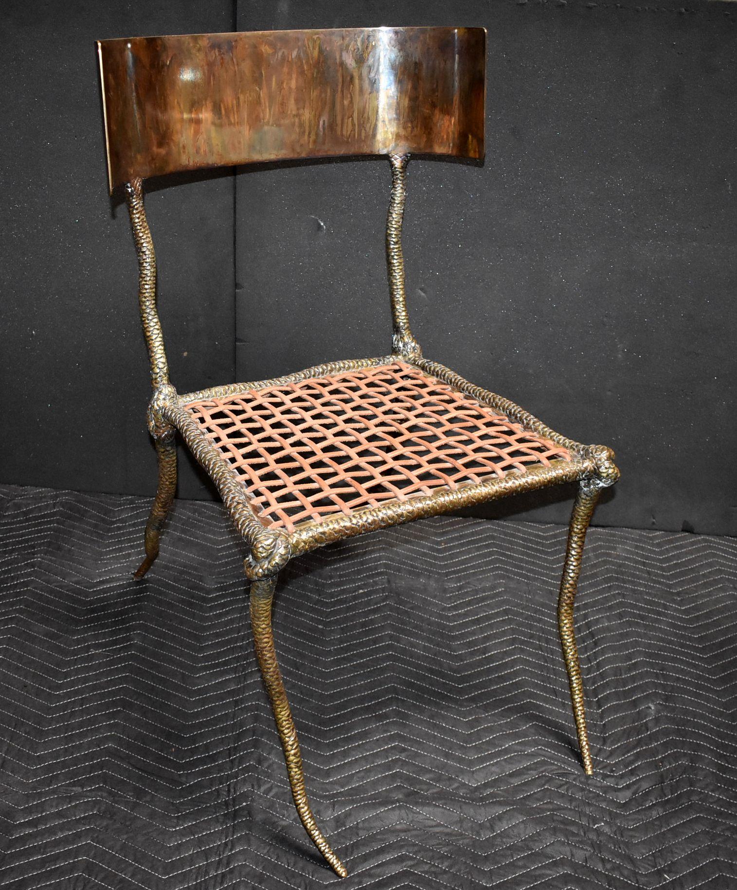 Solid brass sculptural side chair with leather strapping and curve back.(Brass tortoise finish on curve back and dark bronze patina finish on chair). 


Additional dimensions:
Width of curve back 21.50 inches
Width front seat 21 inches
Width