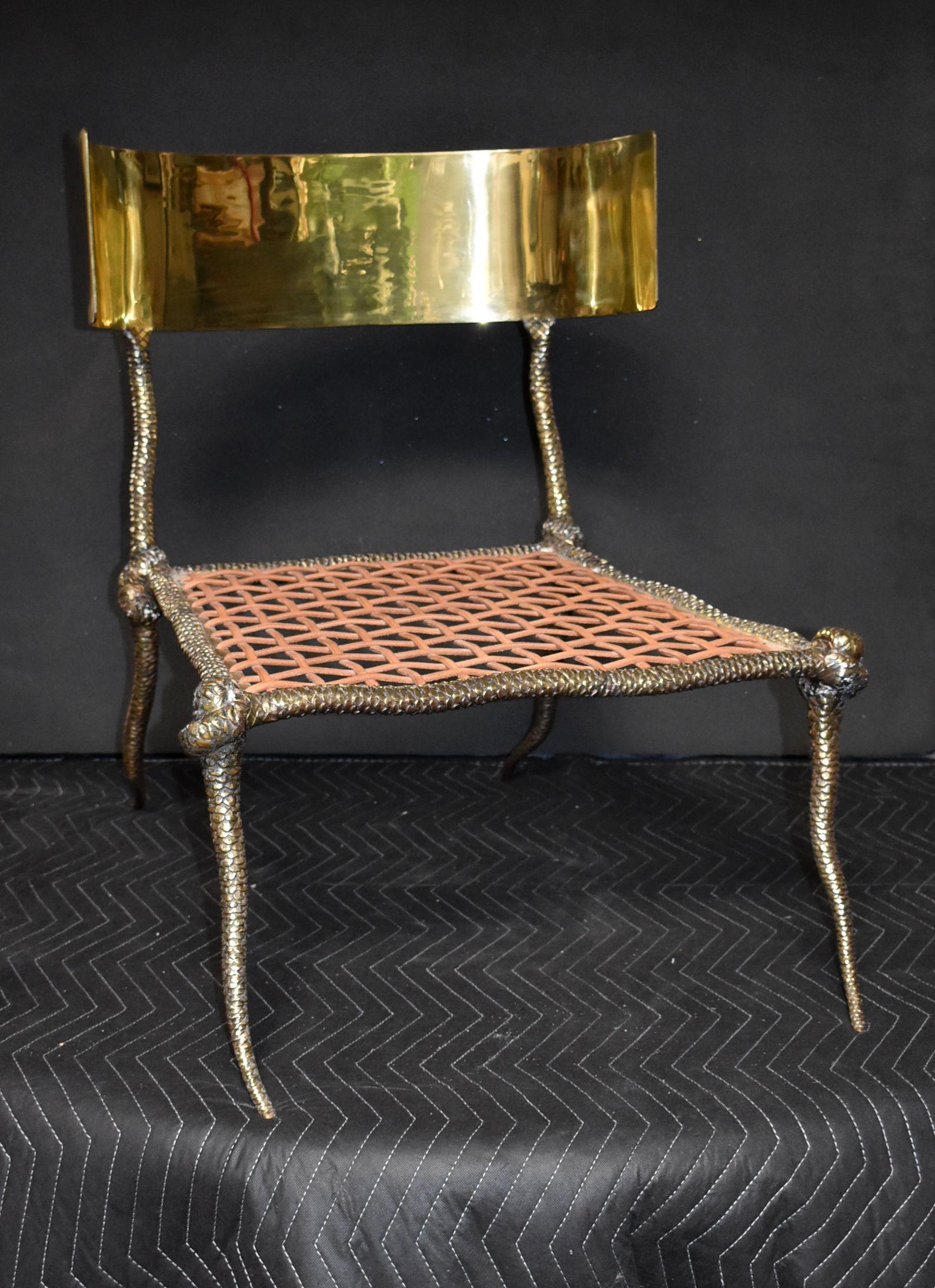 Solid brass sculptural side chair with leather strapping and curve back. 

Additional Dimensions:
Width of curve back 22.50 inches
Width front seat 24 inches
Width back seat 20.50 inches
Depth from front to back legs 31 inches
Height seat without