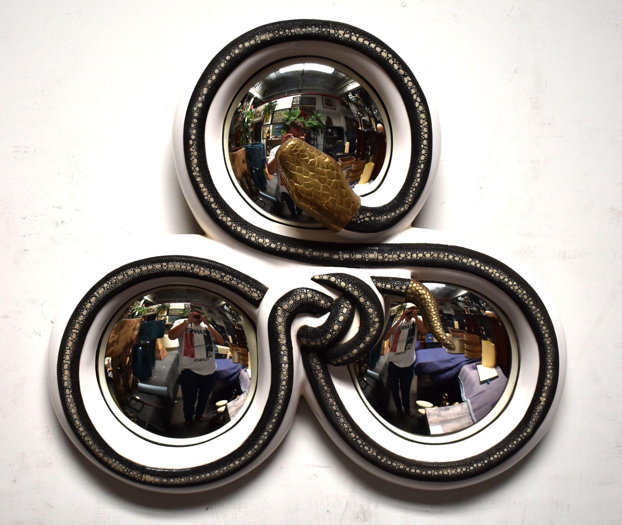 Sculptural convex mirror cover with black and white shagreen cream color frame and solid brass head and tail snake.