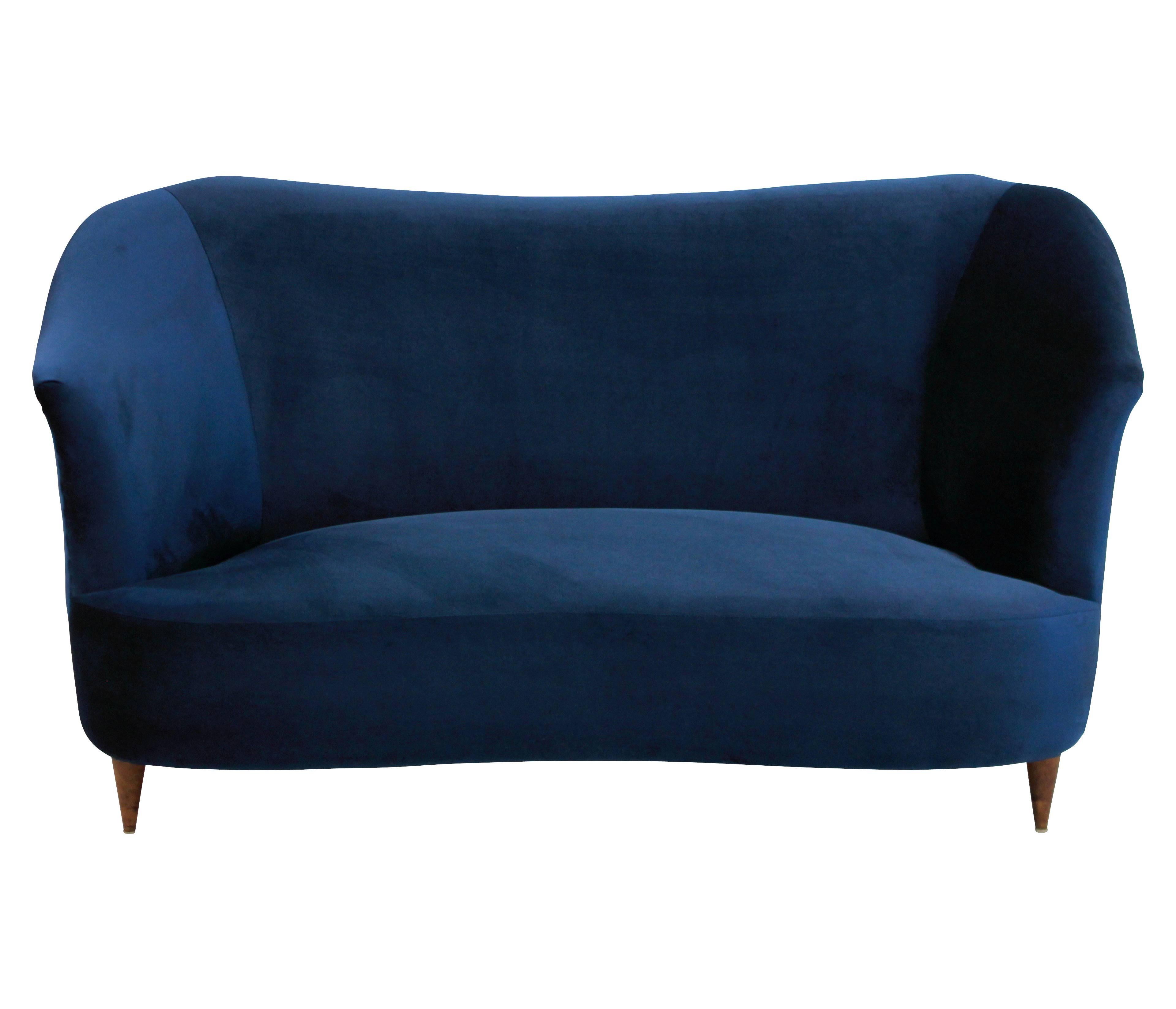 A stylish Italian sculptural sofa by ISA. On turned cherrywood legs and newly upholstered in blue velvet.
  