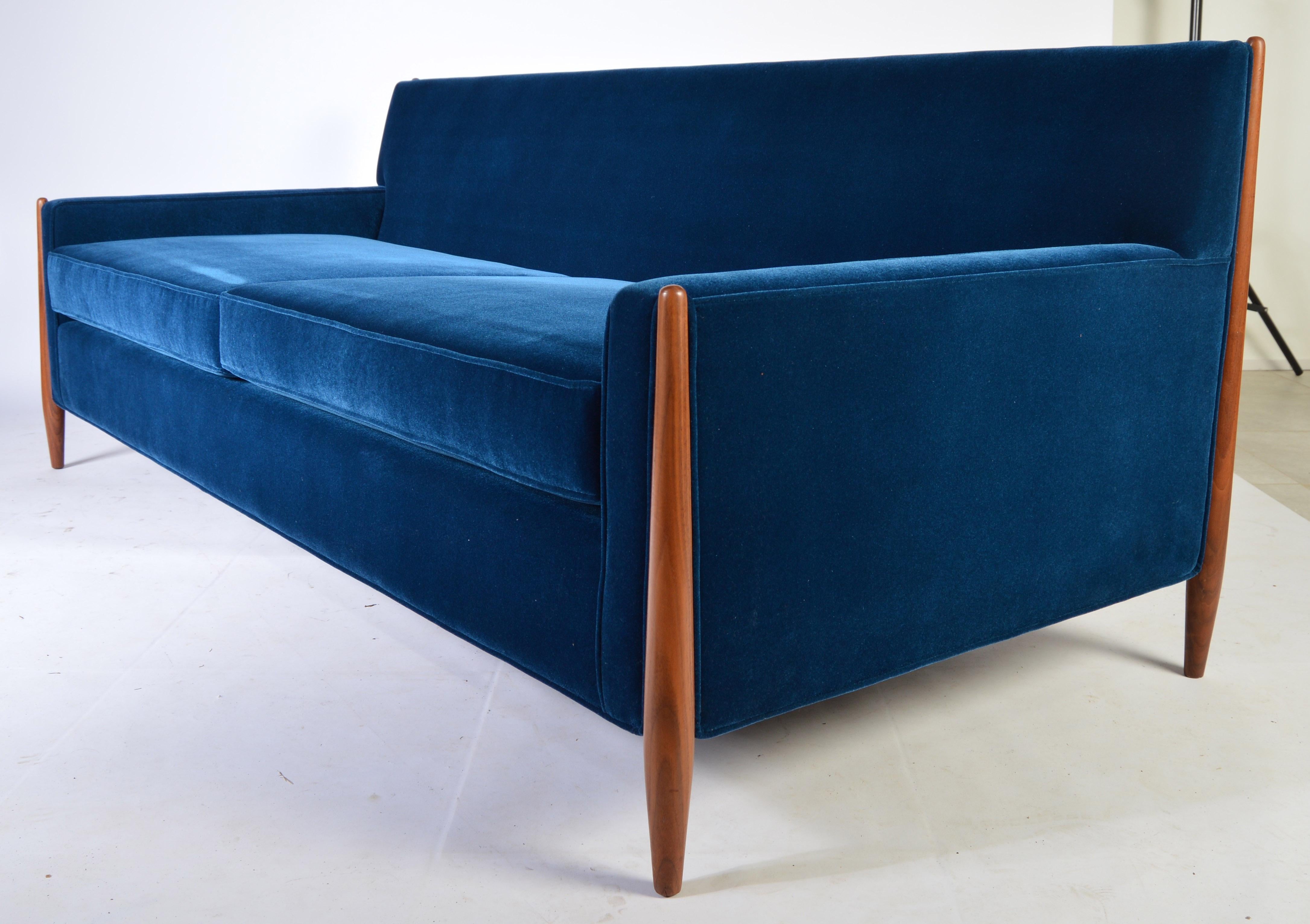 Very comfortable sofa designed by Jules Heumann for Metropolitan, circa 1960s having sculptural walnut legs and midnight blue Lustrous Velvet upholstery.
Reupholstered with new suspension and cushions.
Phenomenal condition.
Measures: 77.5