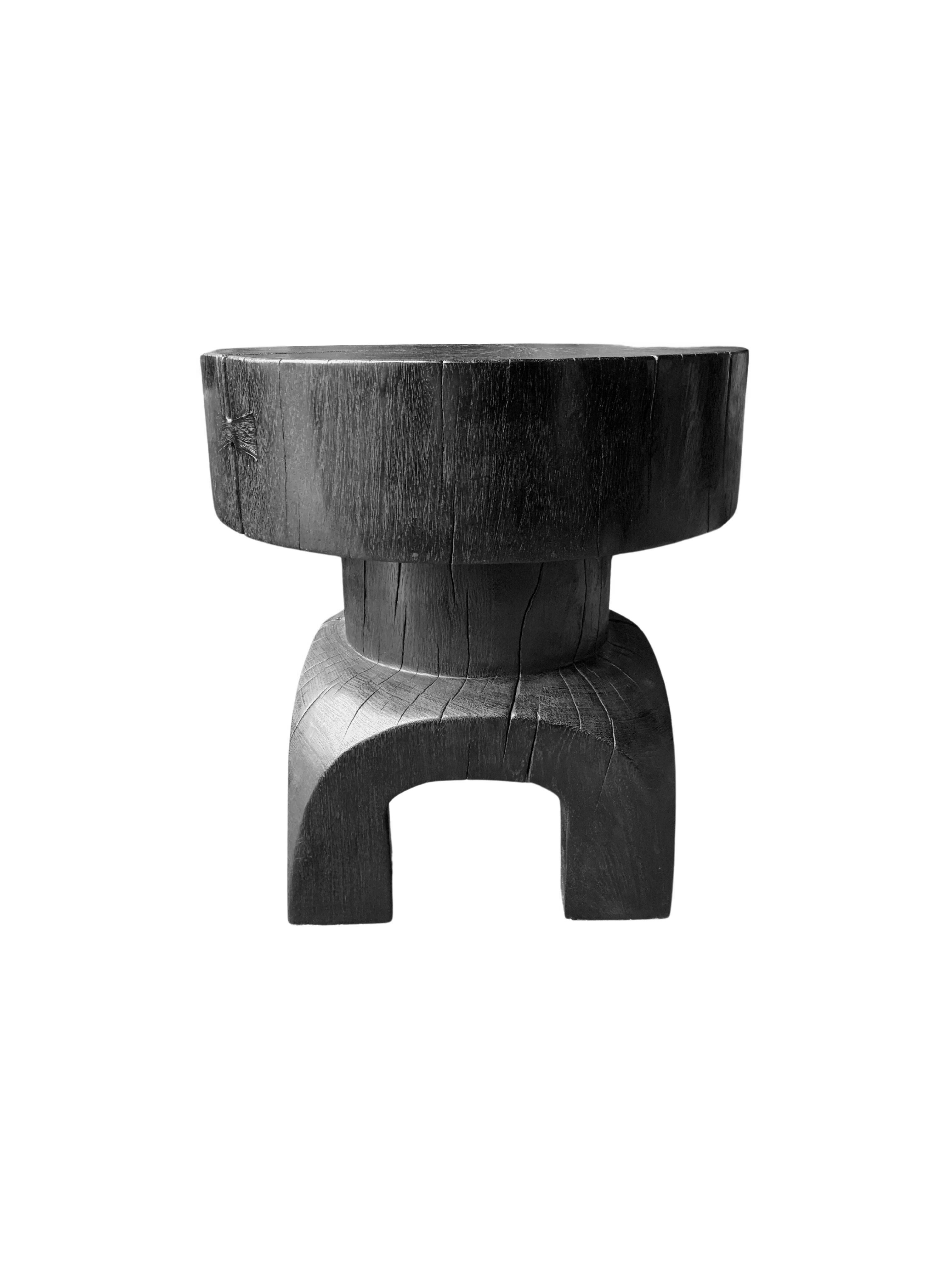 A wonderfully sculptural round side table. Its black pigment was achieved through a burning process creating both a wonderful colour and effect. Its neutral pigment and subtle wood texture makes it perfect for any space. This table was crafted from