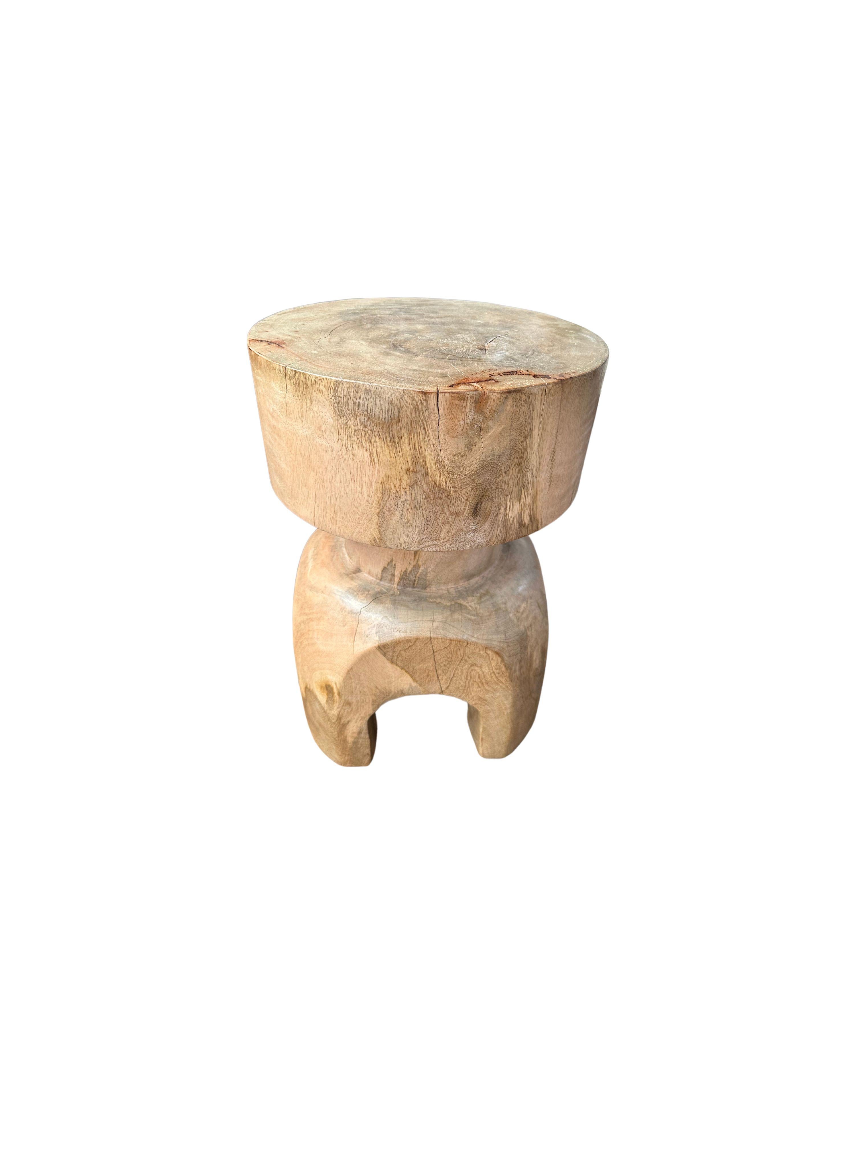 A wonderfully sculptural round side table. Its neutral pigment and subtle wood texture makes it perfect for any space. This table was crafted from solid mango wood and features a natural finish where the wood was sanded and smoothed. 

