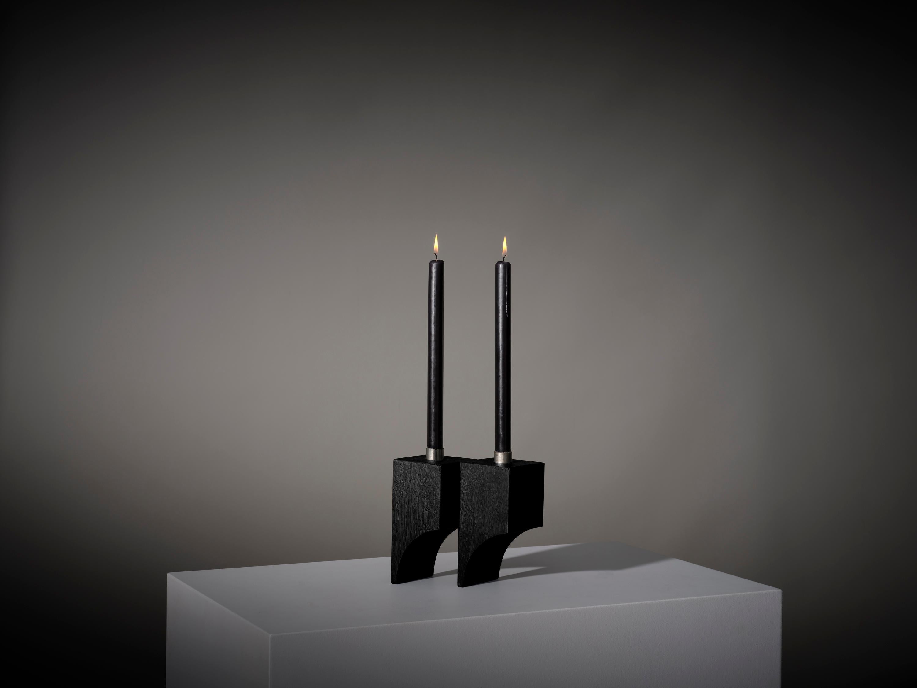 The surrealism inspired Acer candle holder R:2 features architectural cubic volumes and semi arched voids. Designed by Aad Bos and hand crafted in Amsterdam from solid oak wood and steel. 

Mokko is an Amsterdam based design studio with a collection