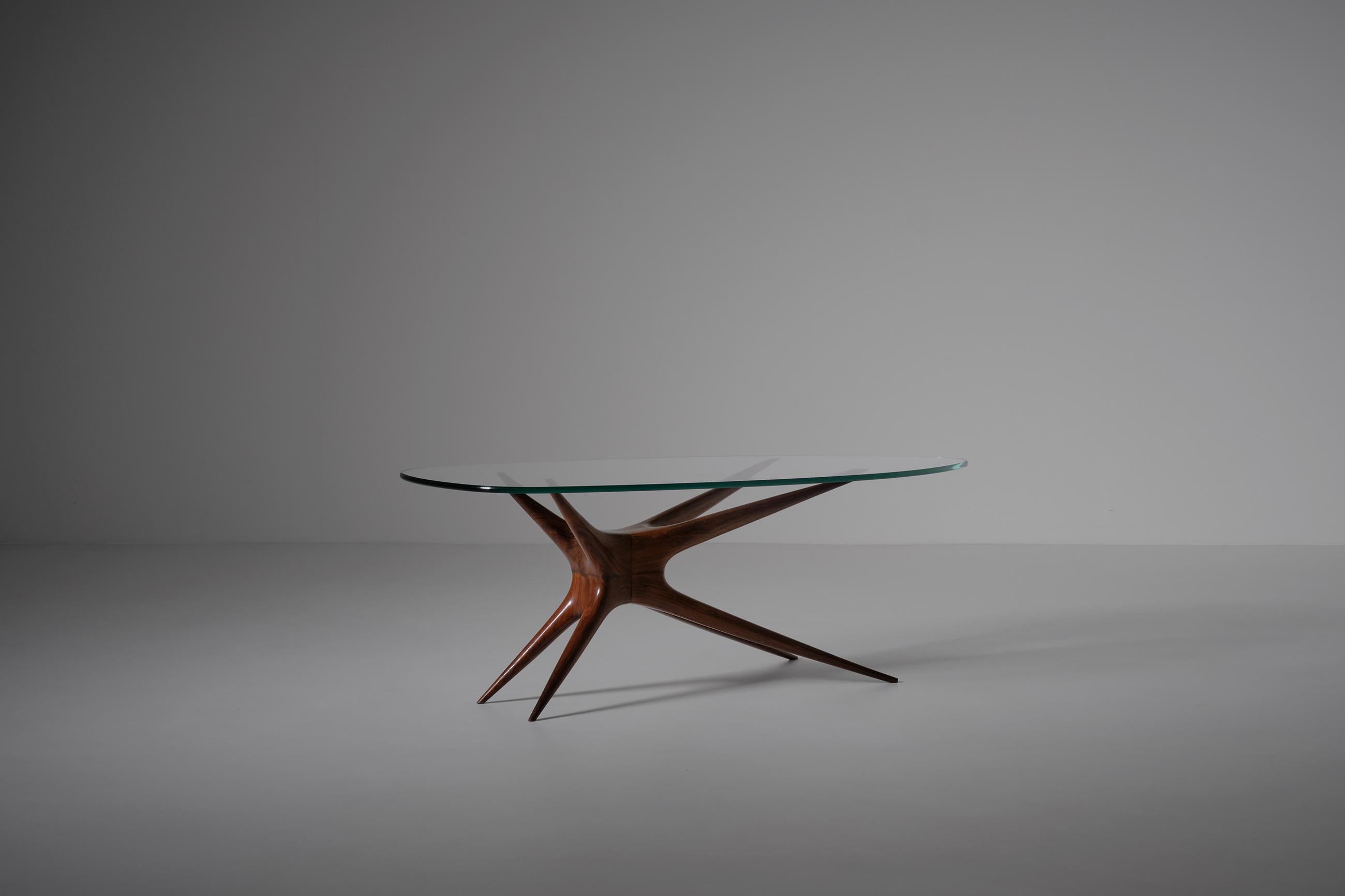 Sculptural coffee table, Italy 1950s. Interesting base from a very refined quality, all crafted out of solid Rosewood. Unfortunately we cannot identify the table but it is from the highest quality. Reminiscent of the work of - and can be attributed