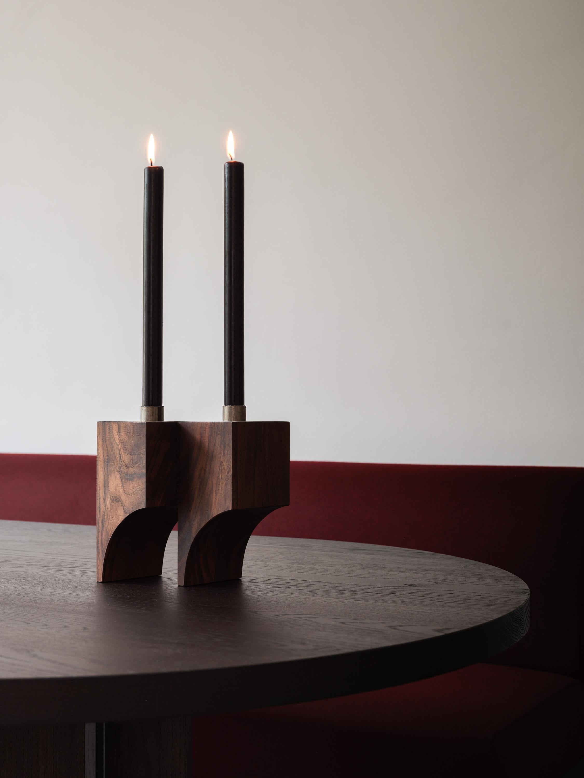 The Acer candle holder R:2 features architectural cubic volumes and semi arched voids. Made out of solid wood and steel, showing signs of handcraft. 

Designed by Aad Bos and crafted in Amsterdam out of solid European oak with a black or dark brown