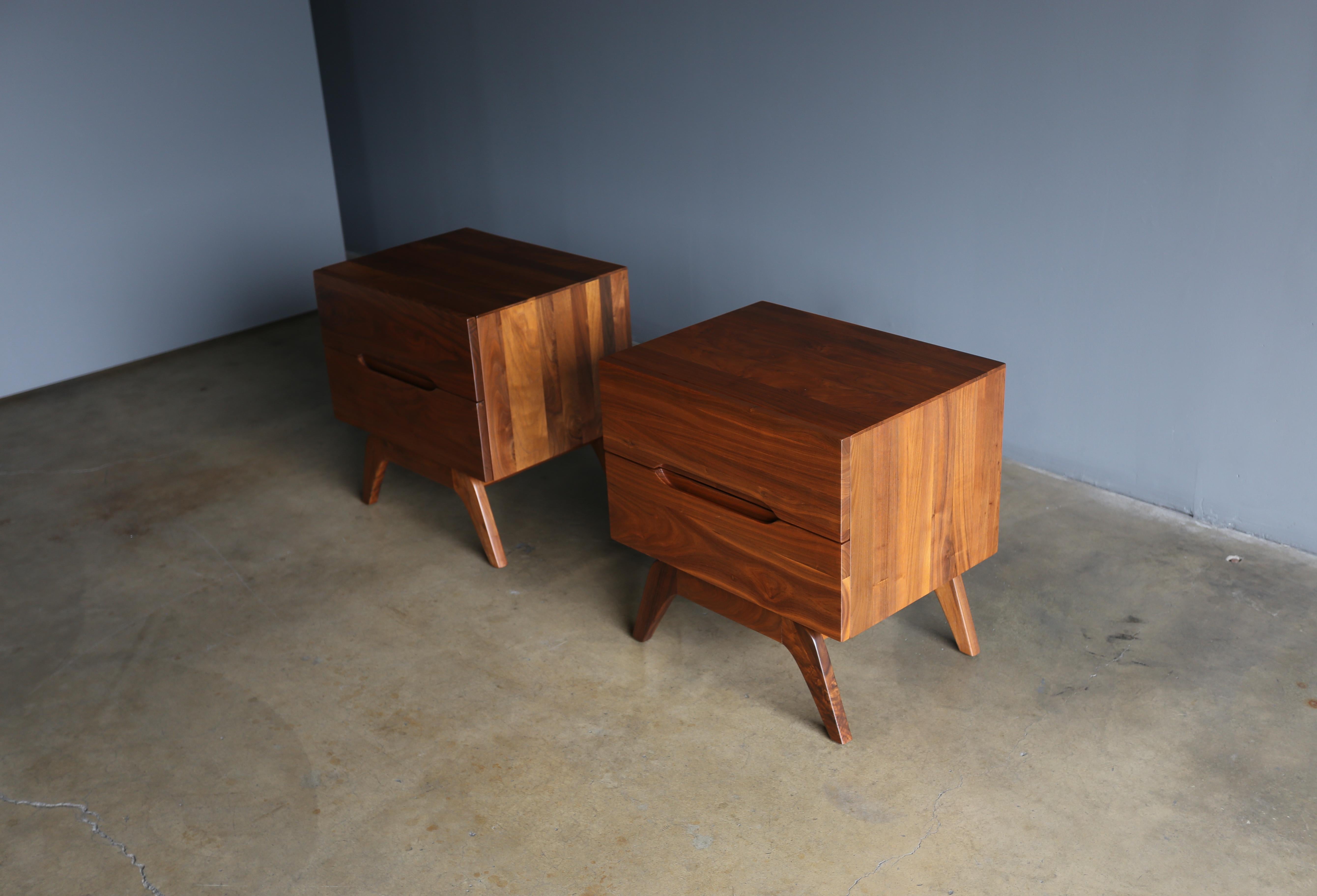 Sculptural solid walnut nightstands, circa 1965. This pair has been professionally restored.