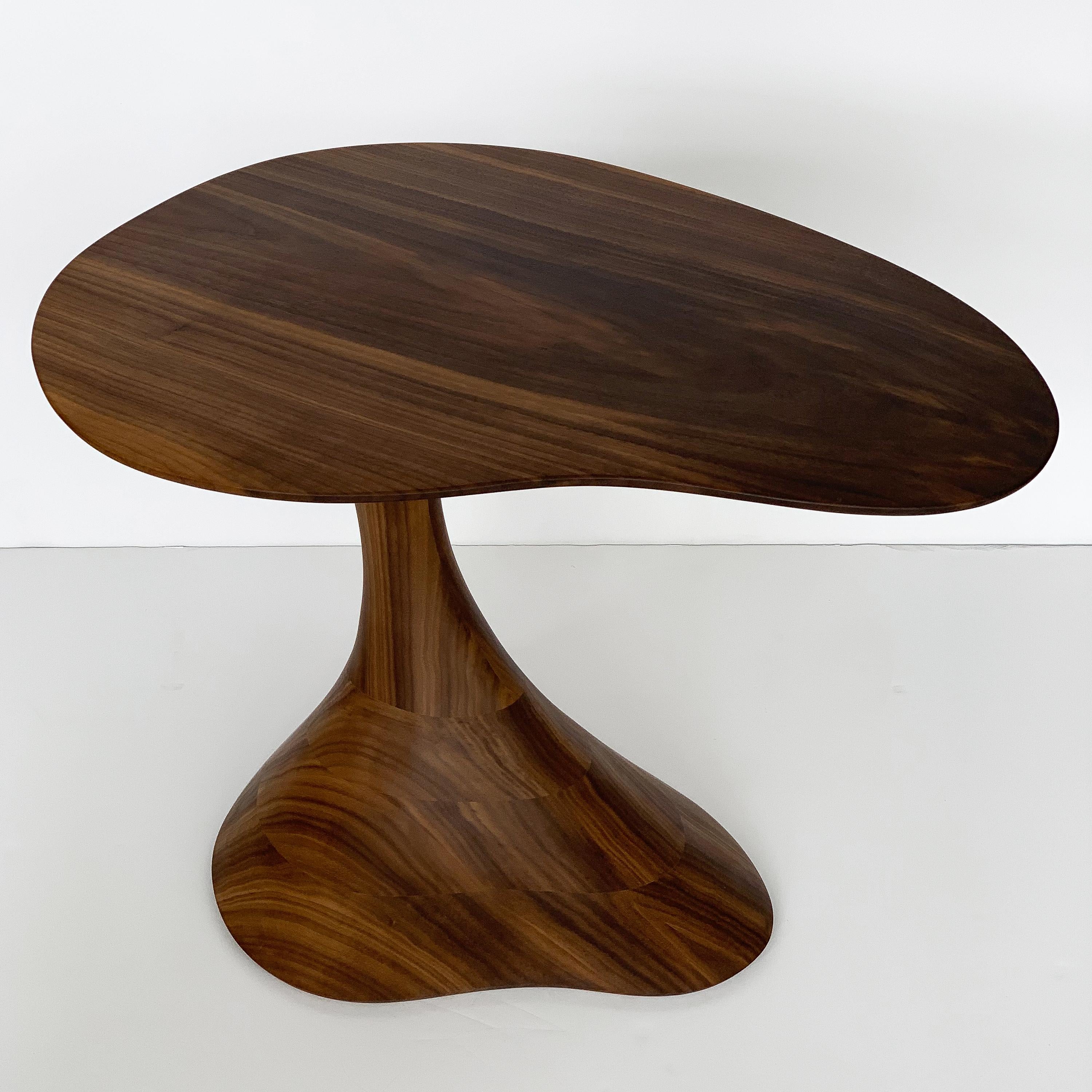 Sculptural solid walnut side tables by Morten Stenbaek. Each Pedem table is hand carved by the artist and each table is a one of a kind shape. Organic and curvaceous in form the entire table is constructed from solid walnut and oil finished.