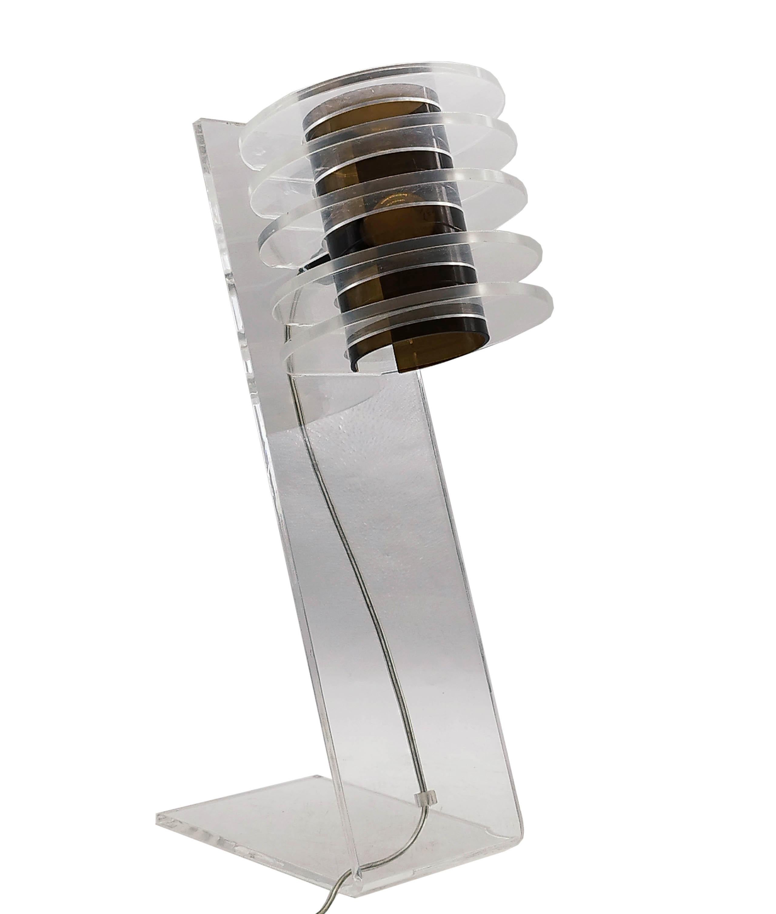 Rare spage age table lamp in transparent and amber stacked circle lucite. Made in Italy in the 1970s In excellent condition and completely original. The unique shape of the lamp gives off a fantastic light when in use.