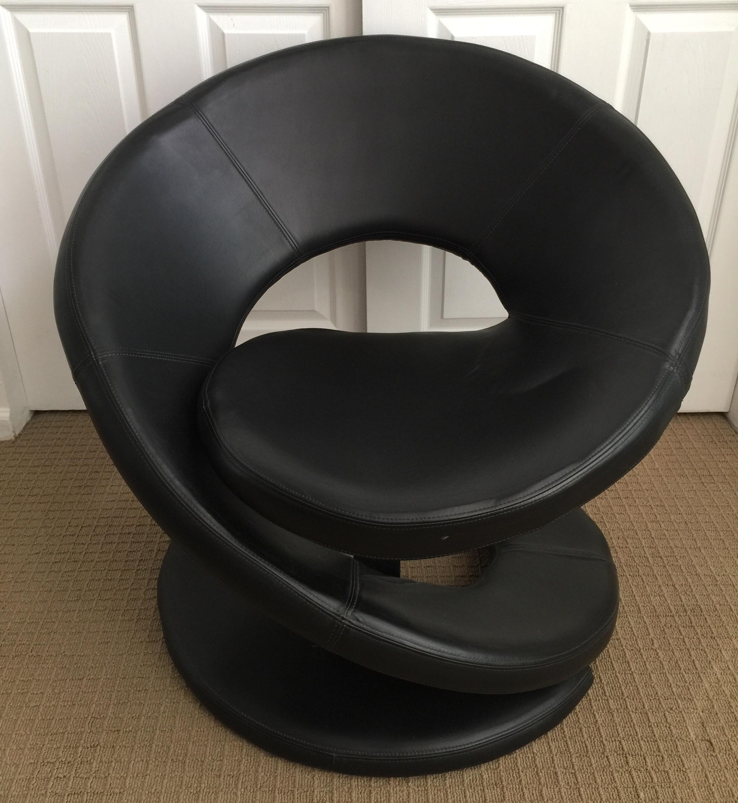 Modern sculptural black leather accent lounge chair. 
Made in Canada.