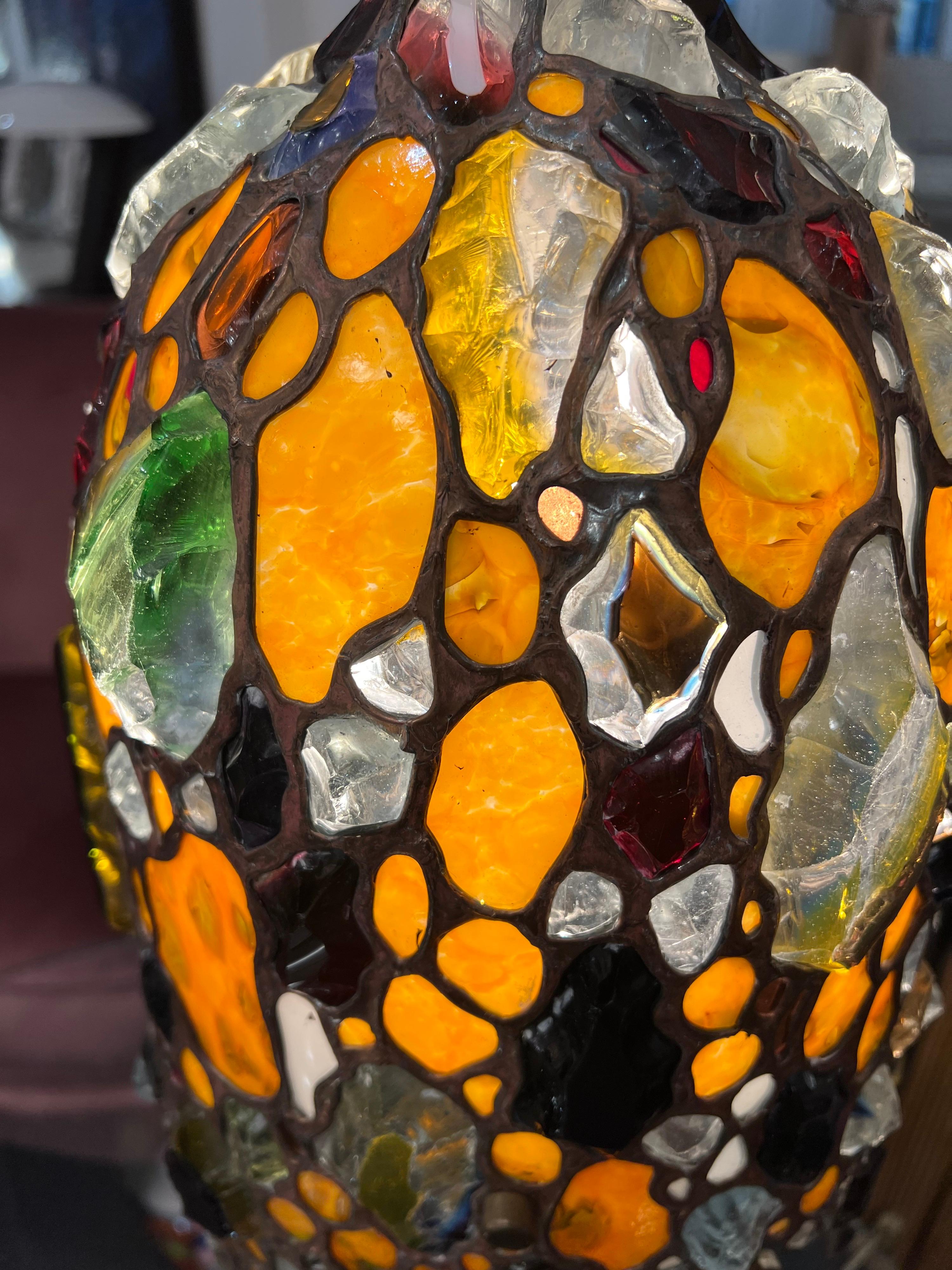 An extraordinary & unique sculptural table lamp in multicoloured stained glass with numerous chunks of faceted gemlike glass standing on a solid marble base . Truly amazing Italian craftsmanship from the 1970s