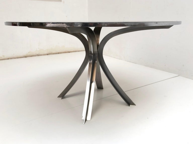Superb design by French designer Xavier Feal for Inox Industrie, France, circa 1970

- Large round sculptural dining room table
- Original smoked glass tray encircled with chromed steel
- Resting on a curved brushed stainless steel